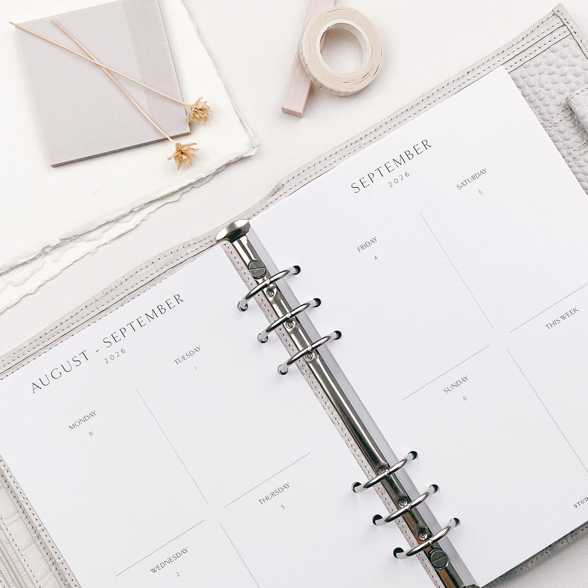 Open planner with September pages on a white surface