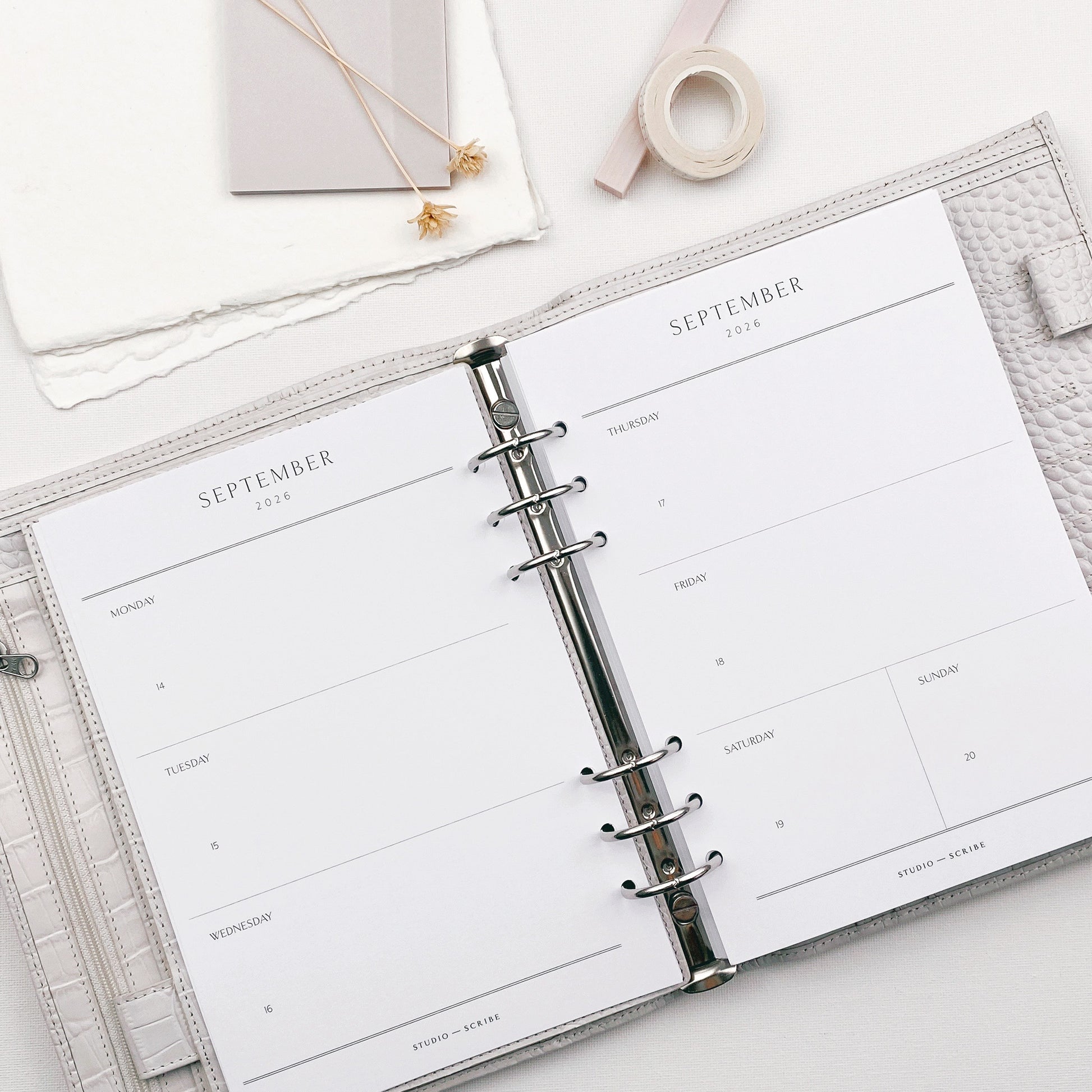 Open planner with September weekly layout on a white surface