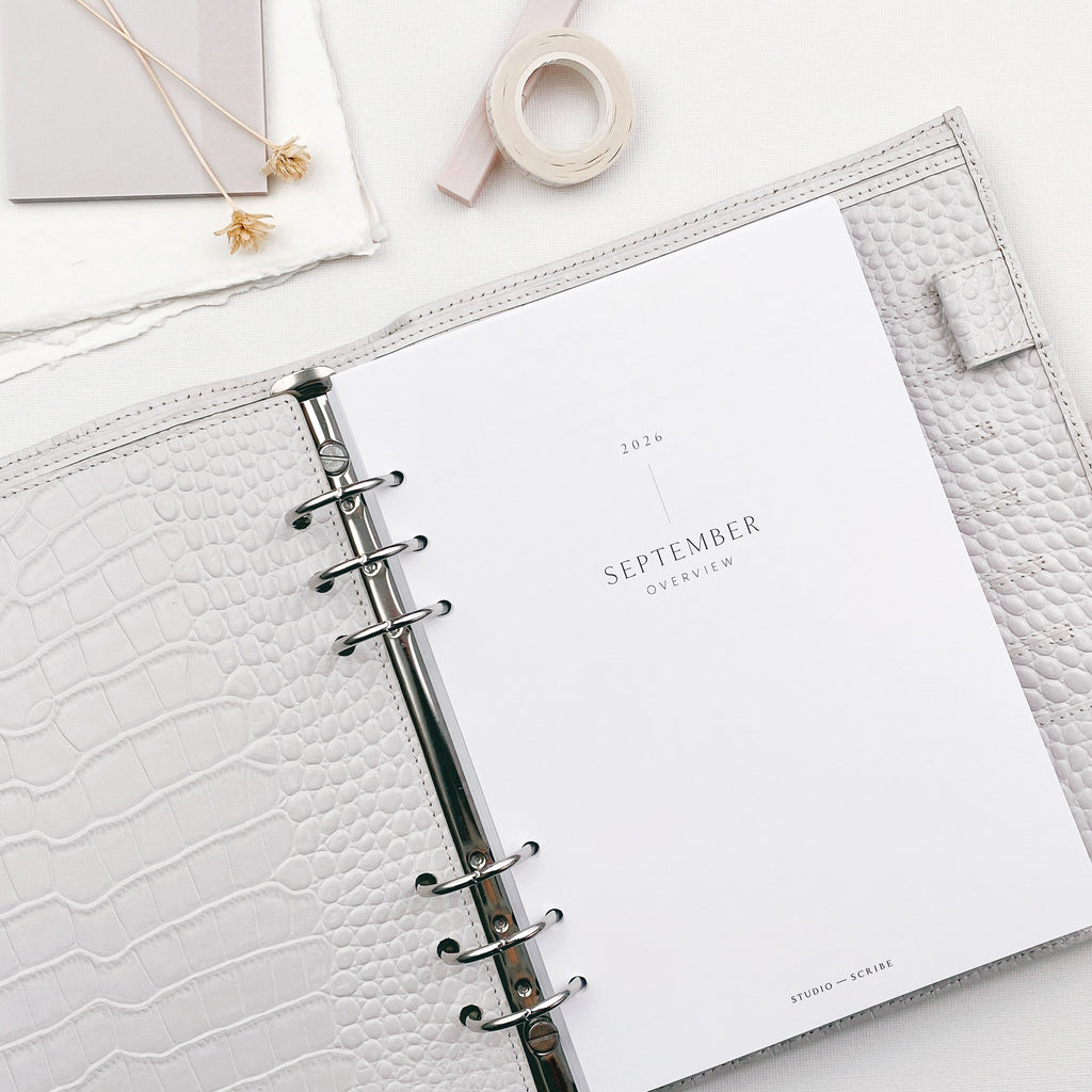 Open planner with September title page on a white surface
