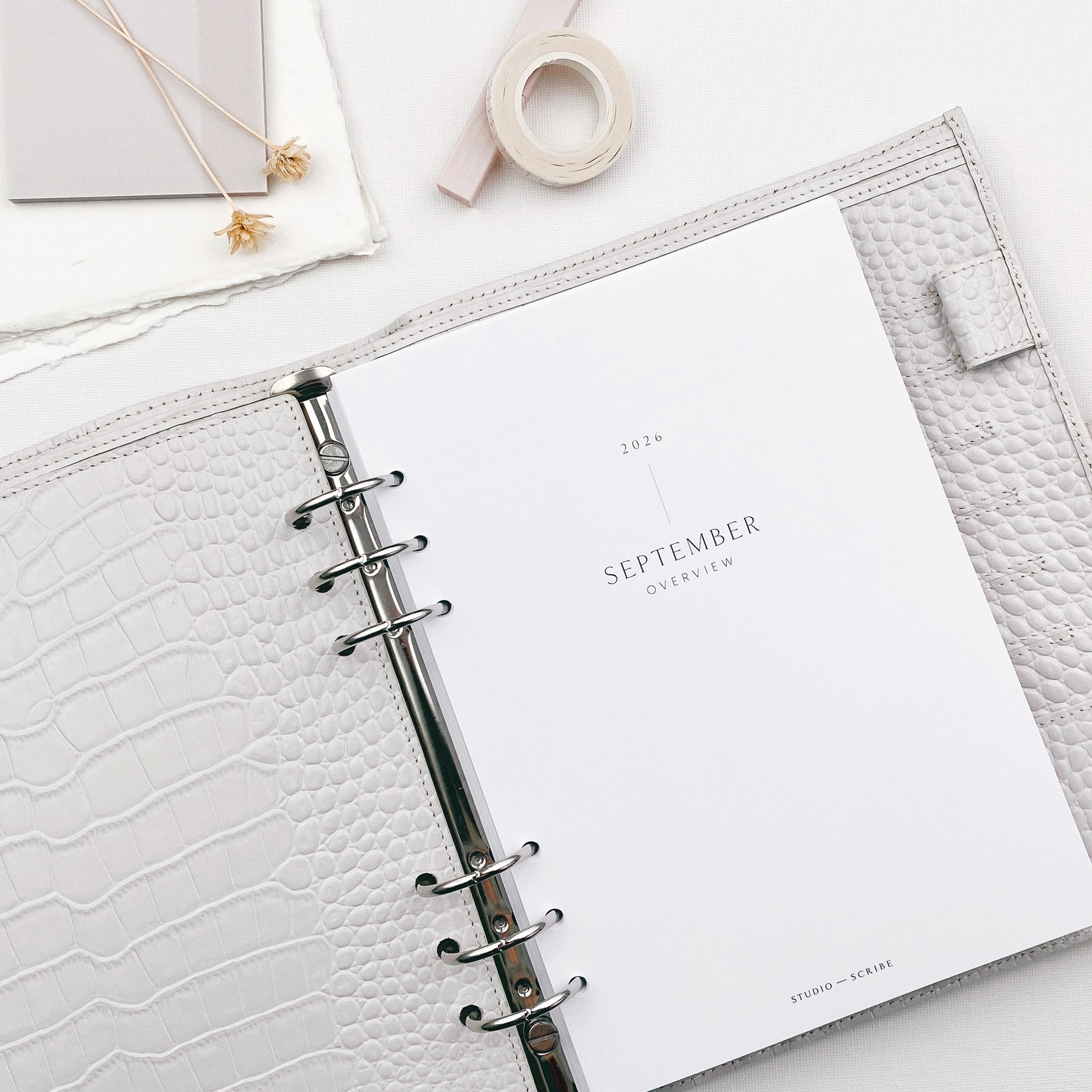 Open planner with September title page on a white surface