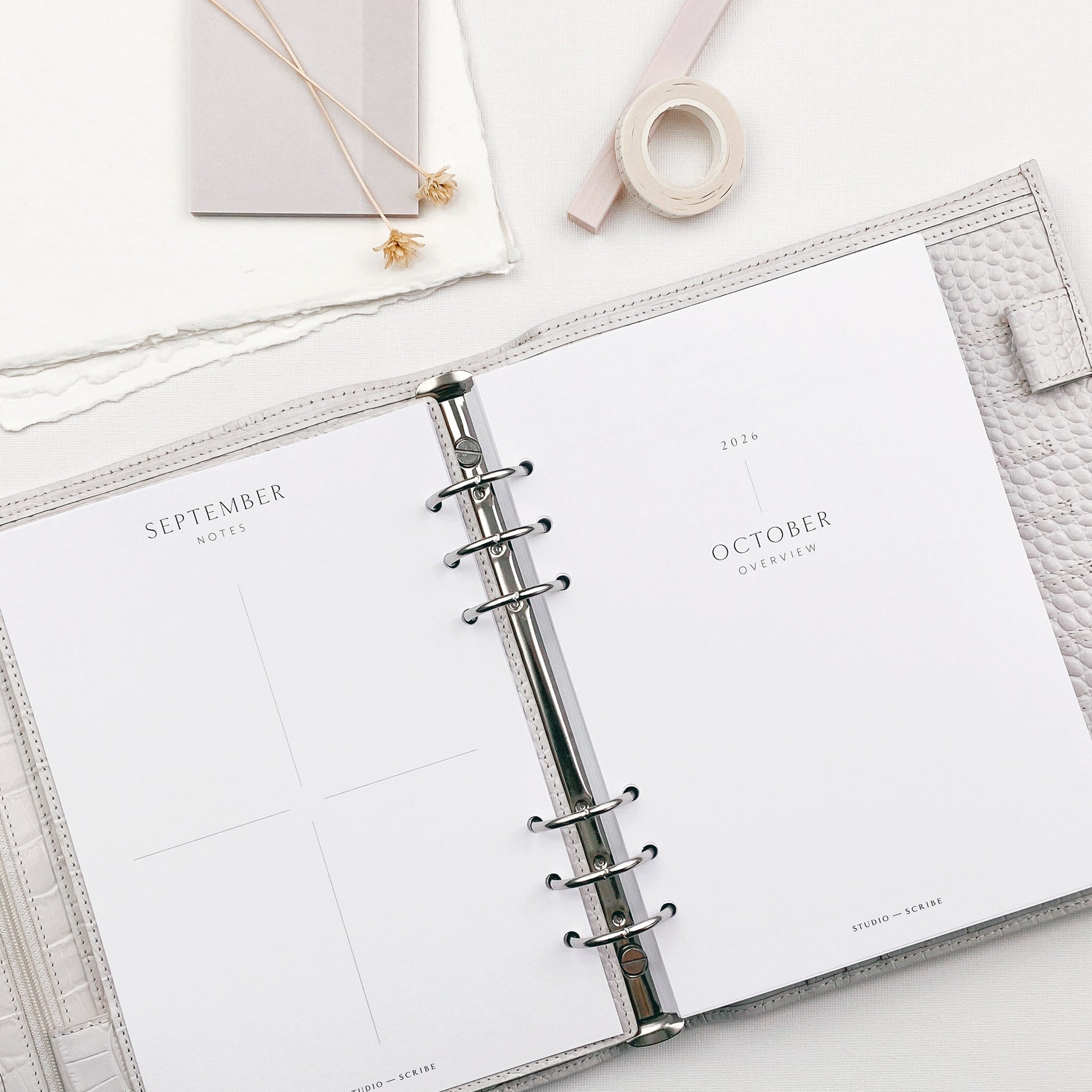 Open planner with a focus on September and October pages, on a light surface.