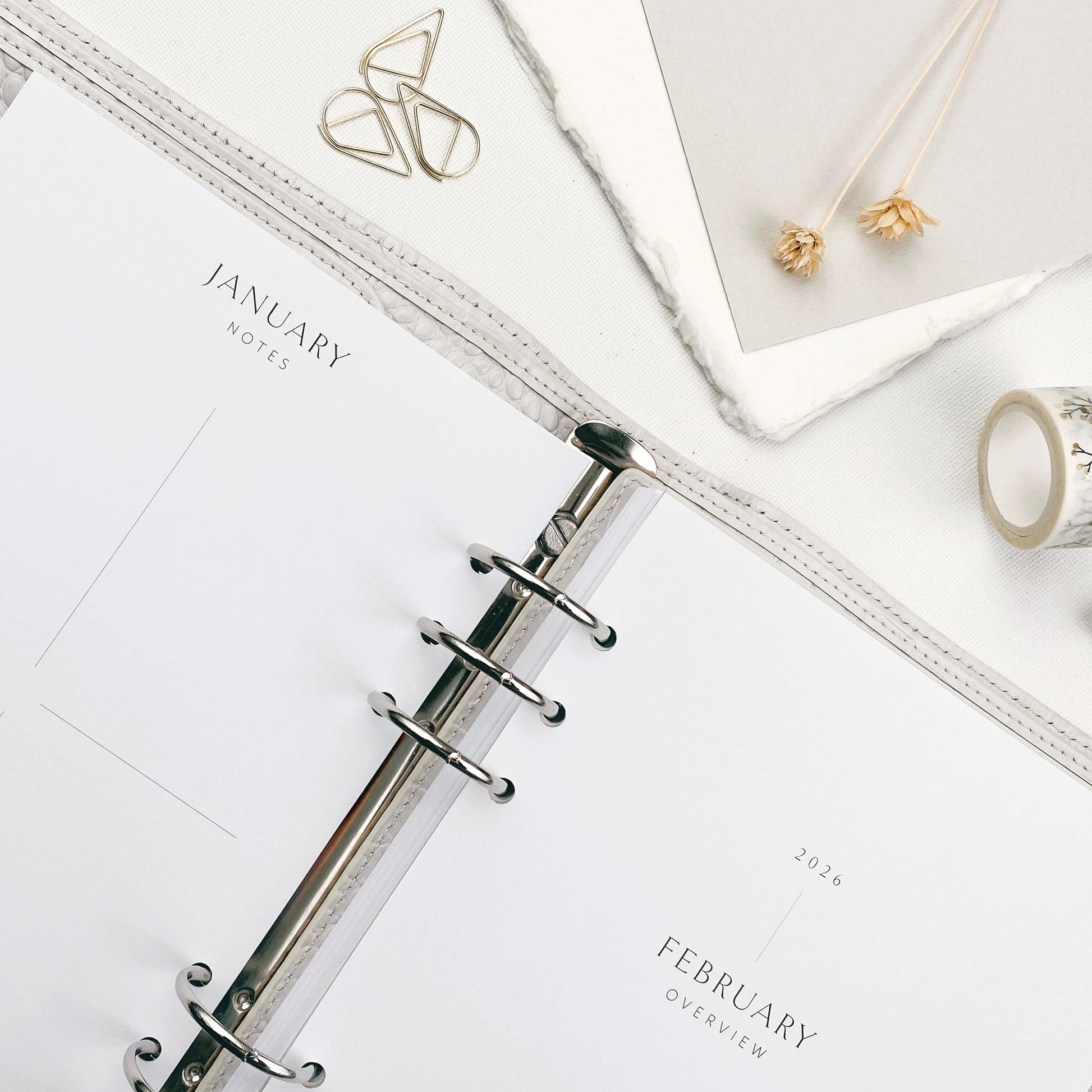 Planner pages with monthly sections on a white surface