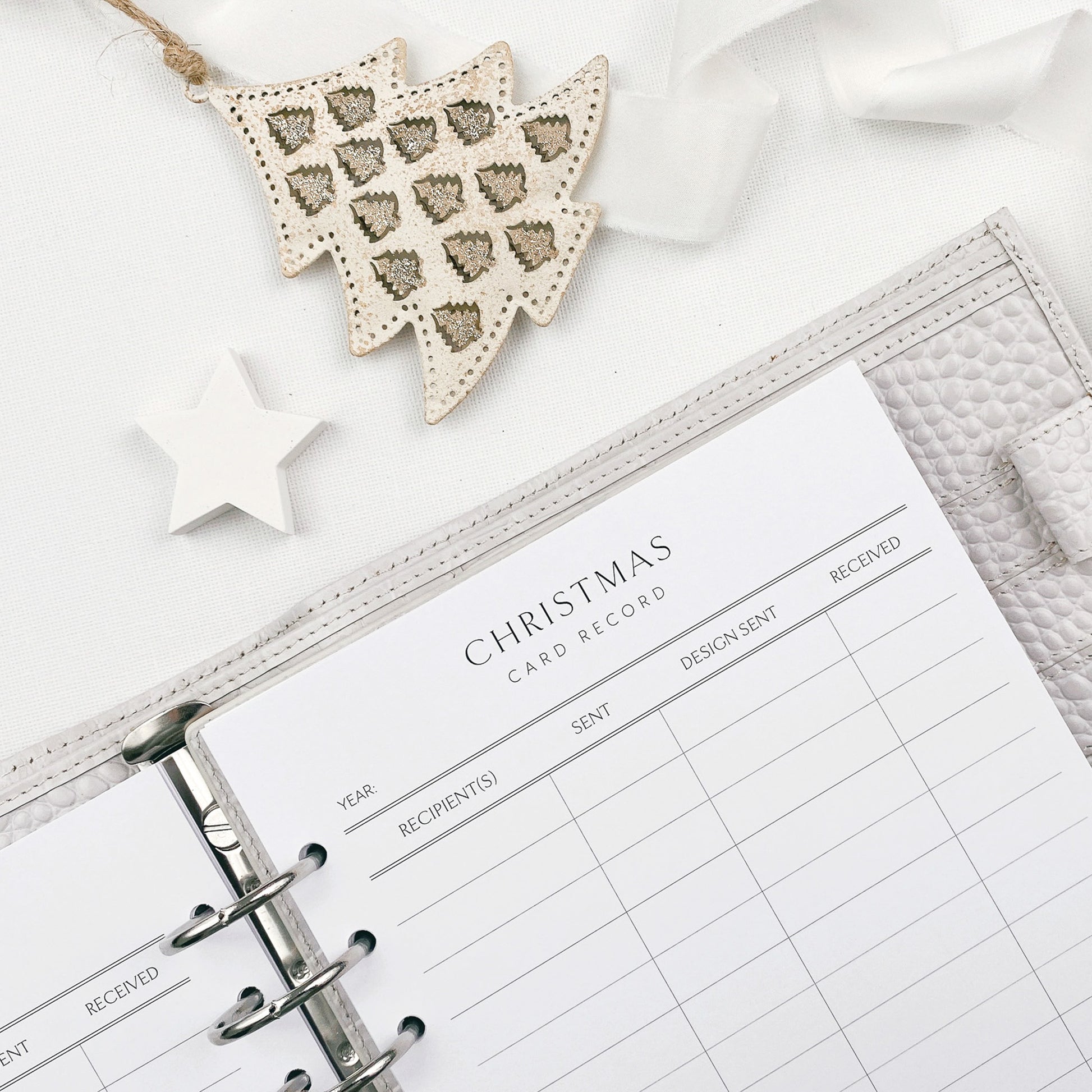 Christmas card record pages with decorative tree ornament on a white background