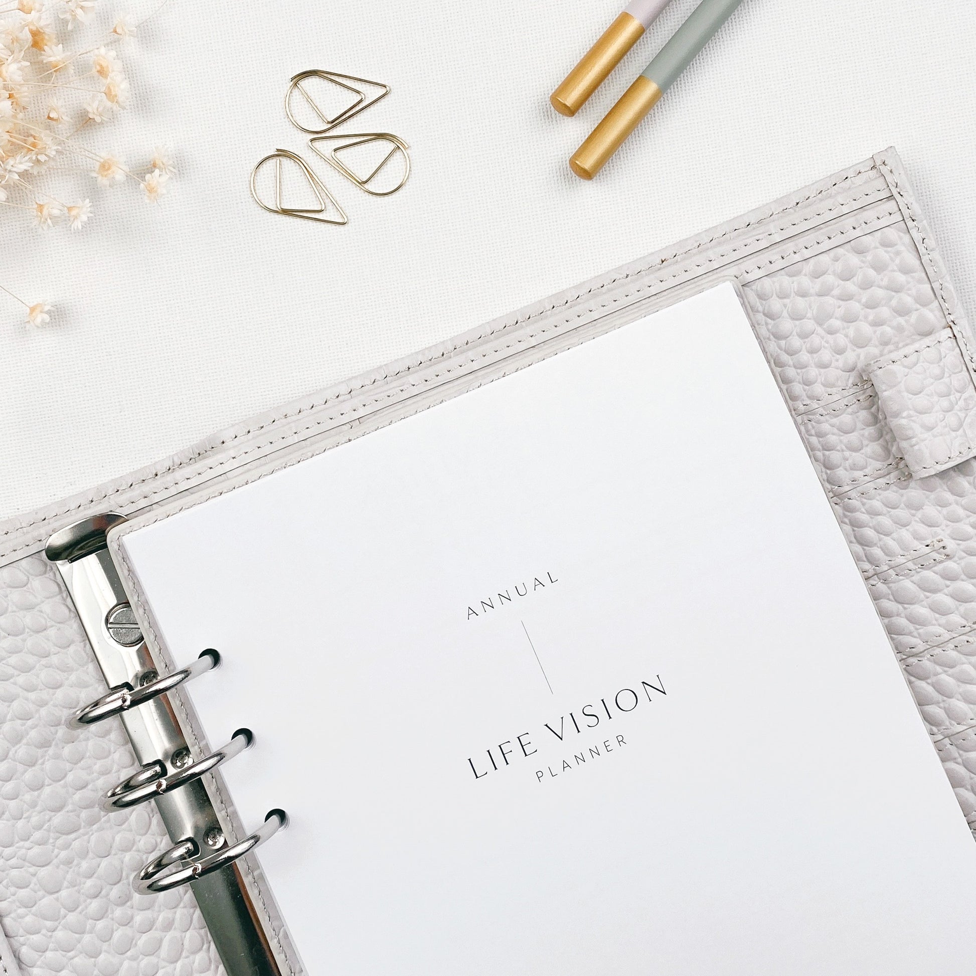 Life vision planner on a white surface with decorative items