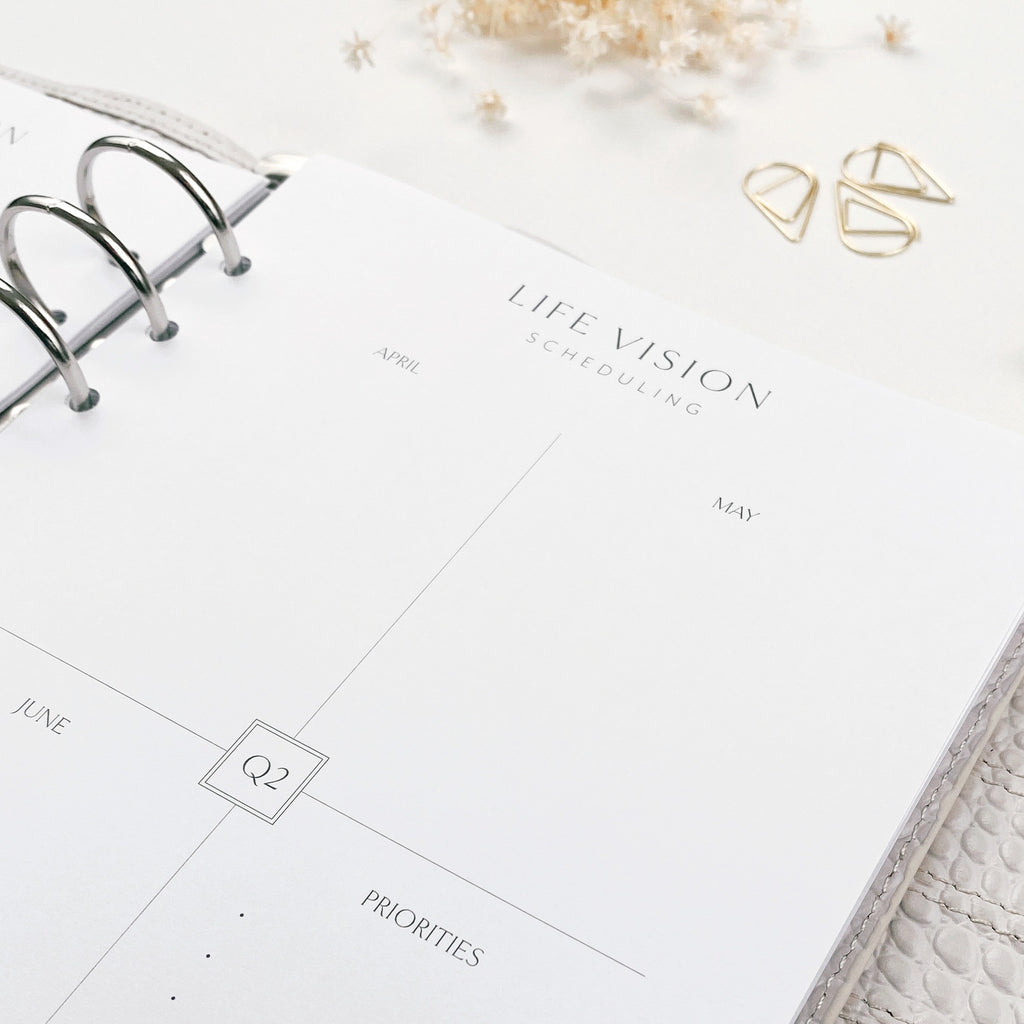 Life vision scheduling planner on a white surface with decorative elements