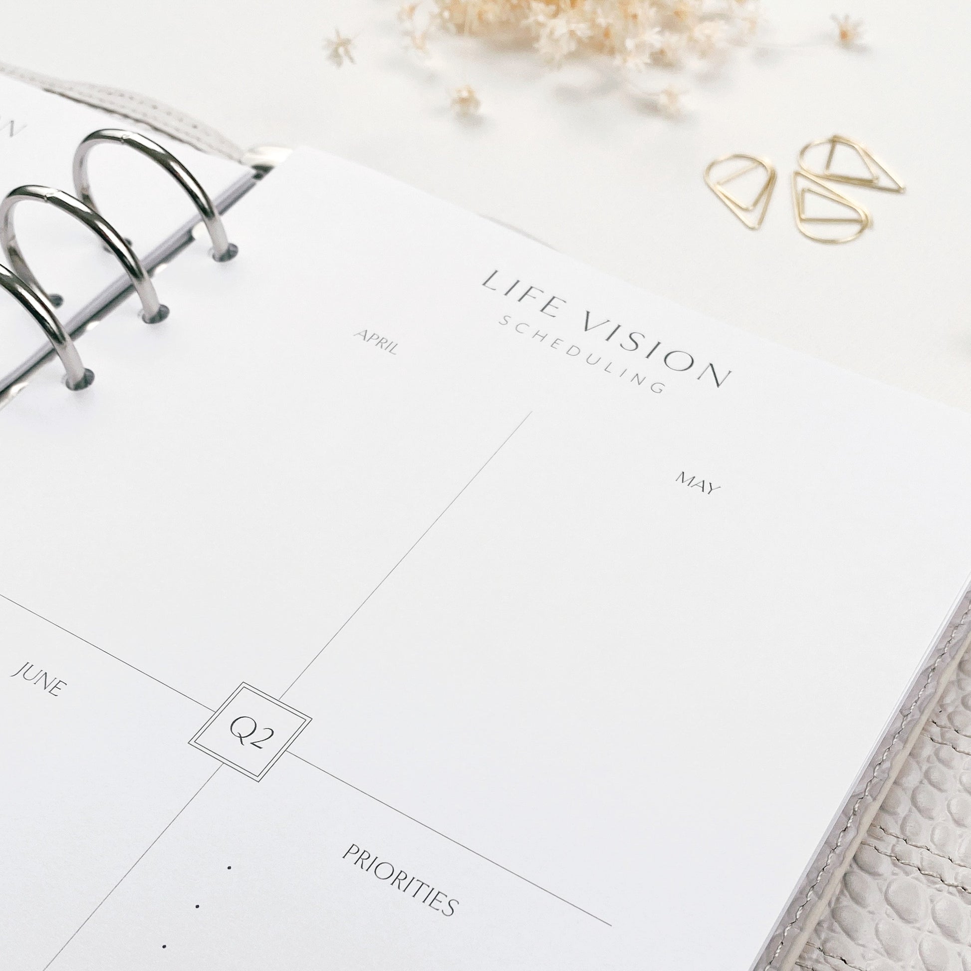 Life vision scheduling planner on a white surface with decorative elements