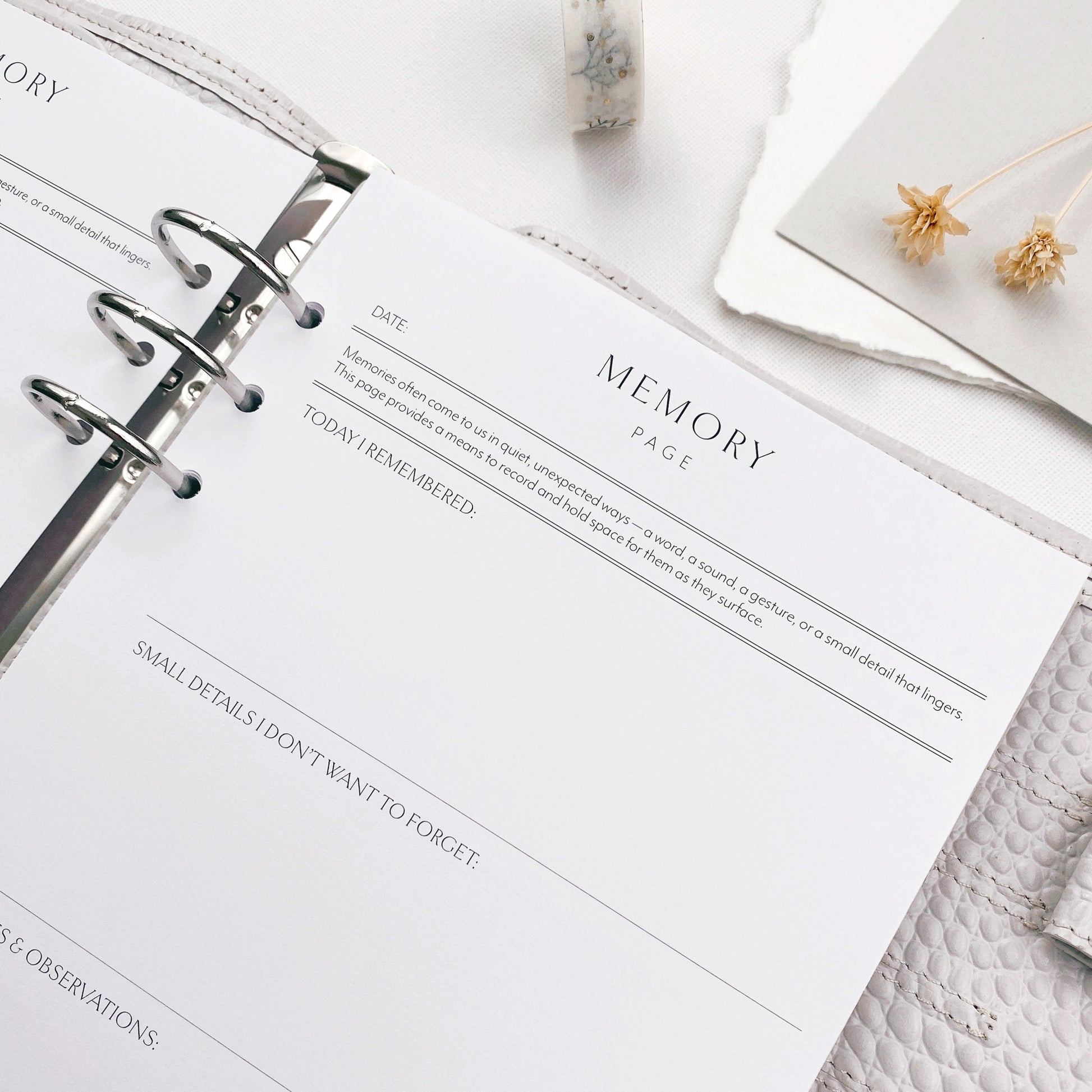 Memory page in a planner with decorative items on a textured surface