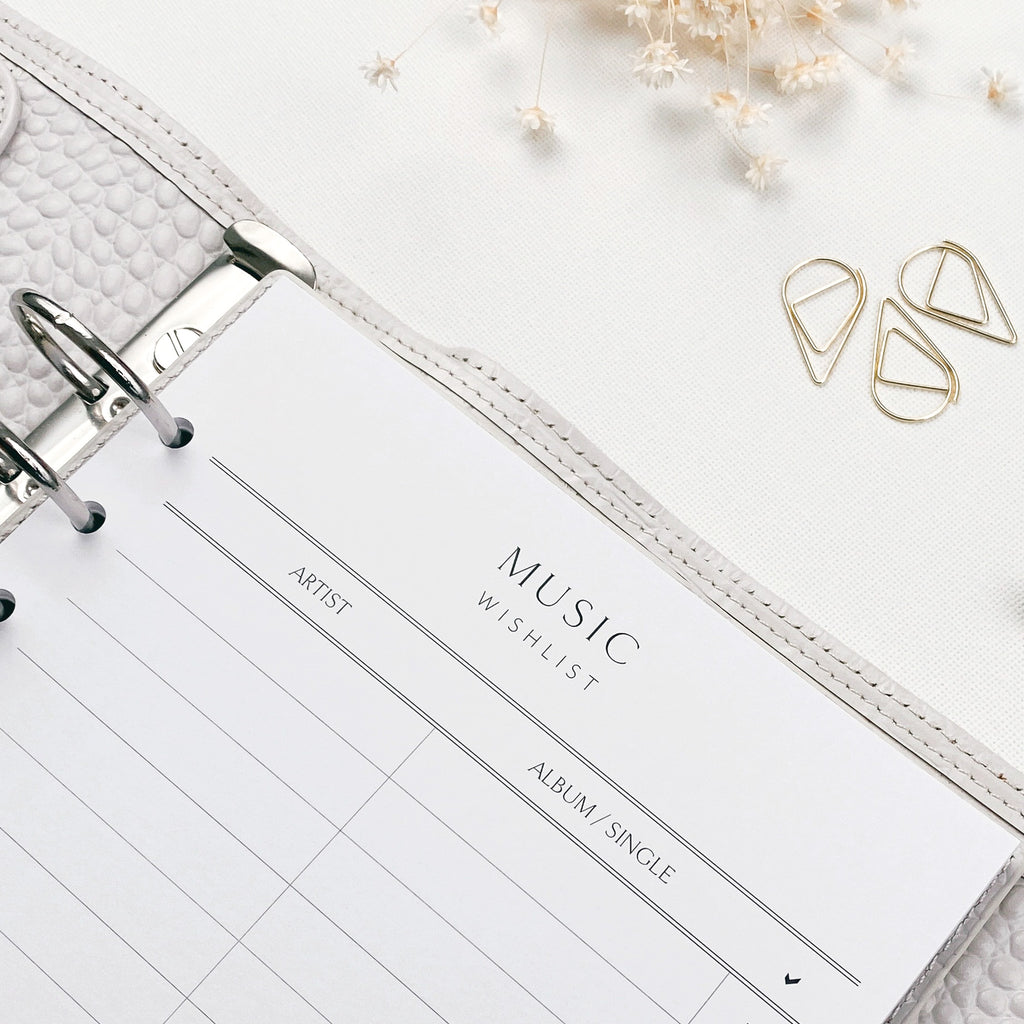 Music wishlist list in a planner with decorative elements on a light background