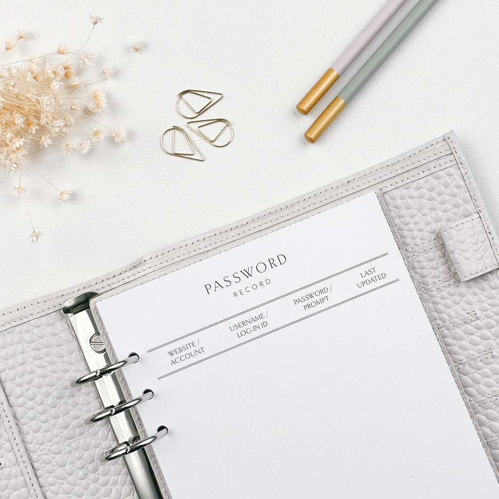 Password record planner page with pencils and decorative elements on a light surface