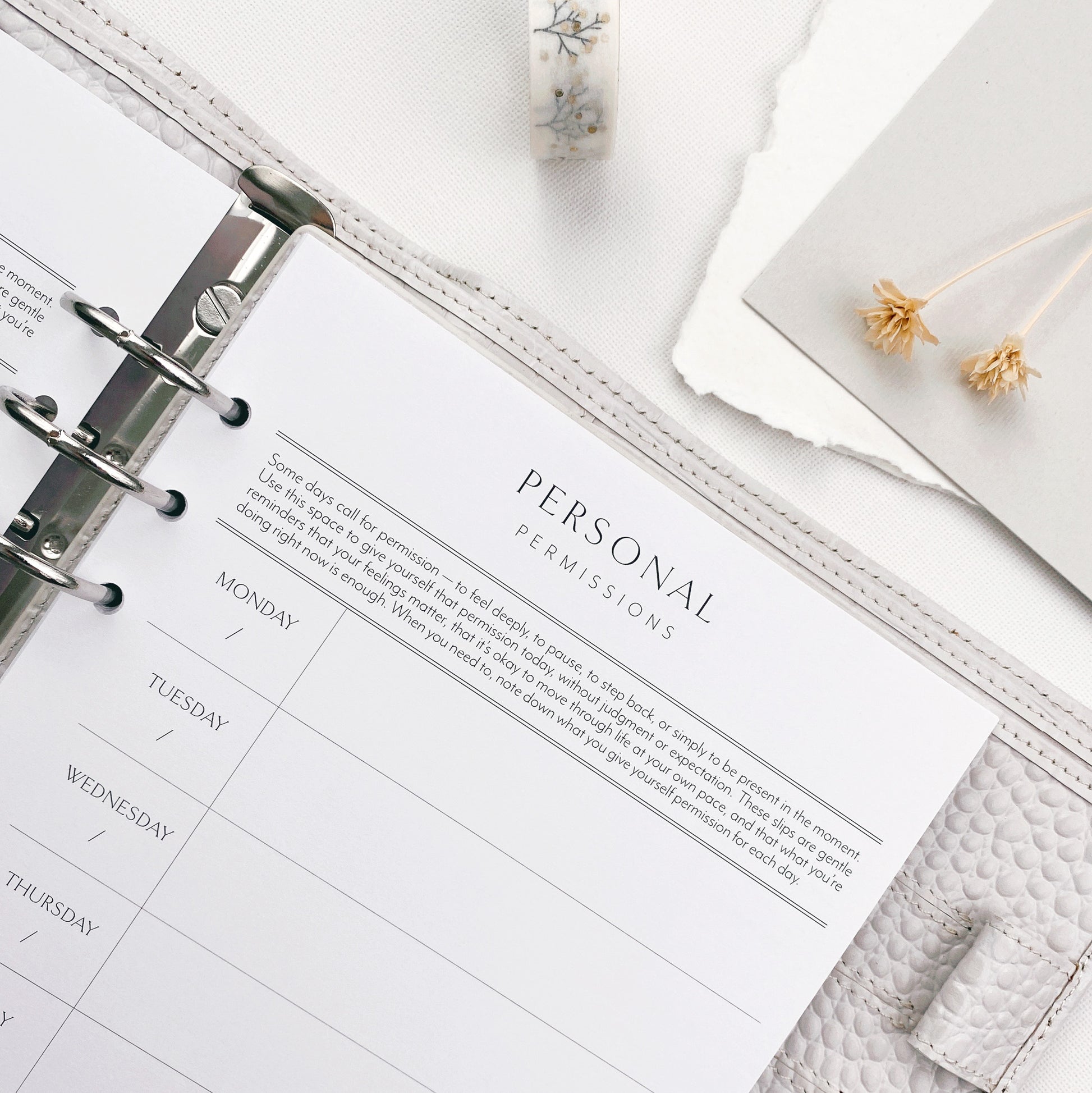 Planner open to a personal permissios slip page on a white surface