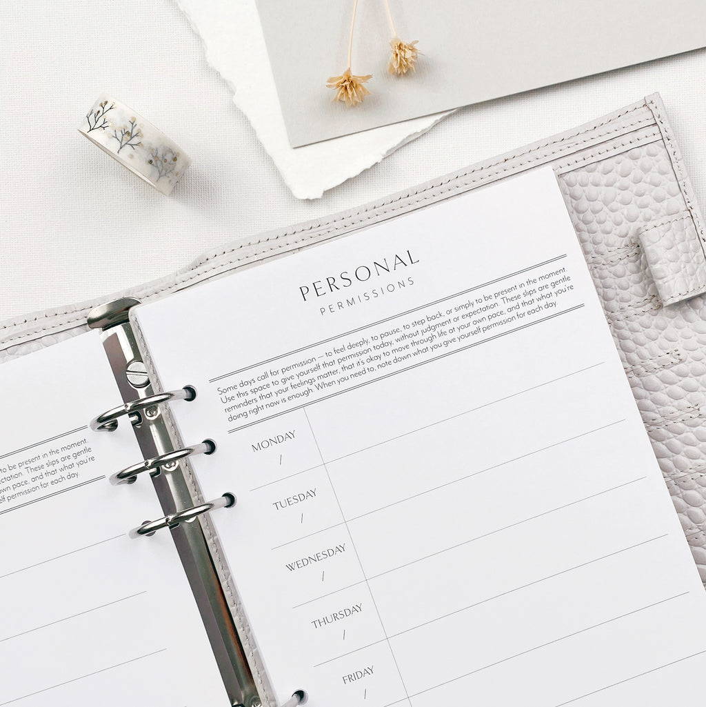 Planner open to a personal permissios slip page on a white surface