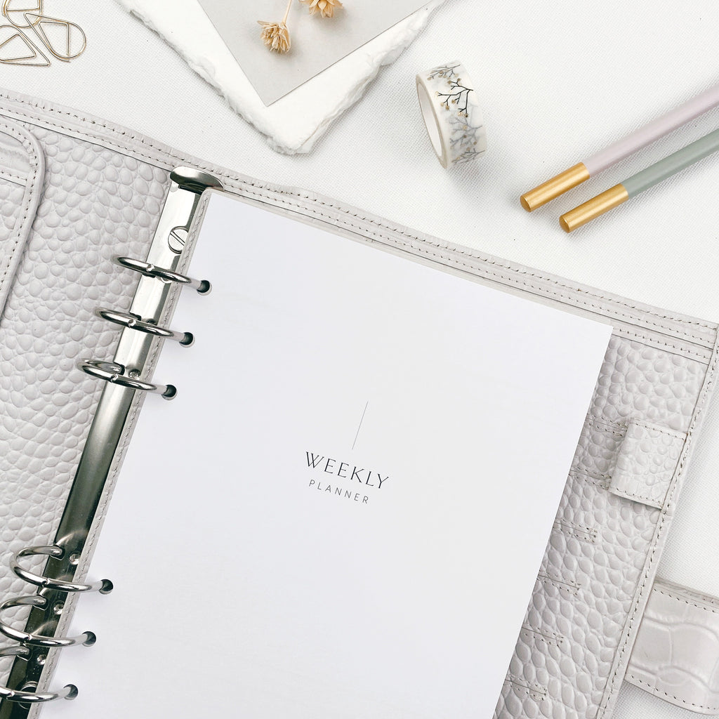 Undated weekly planner with decorative elements on a light background