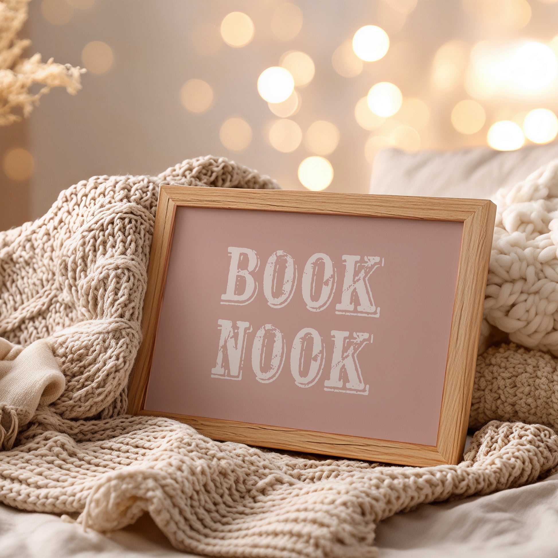 Framed artwork with 'BOOK NOOK' text on a pink background