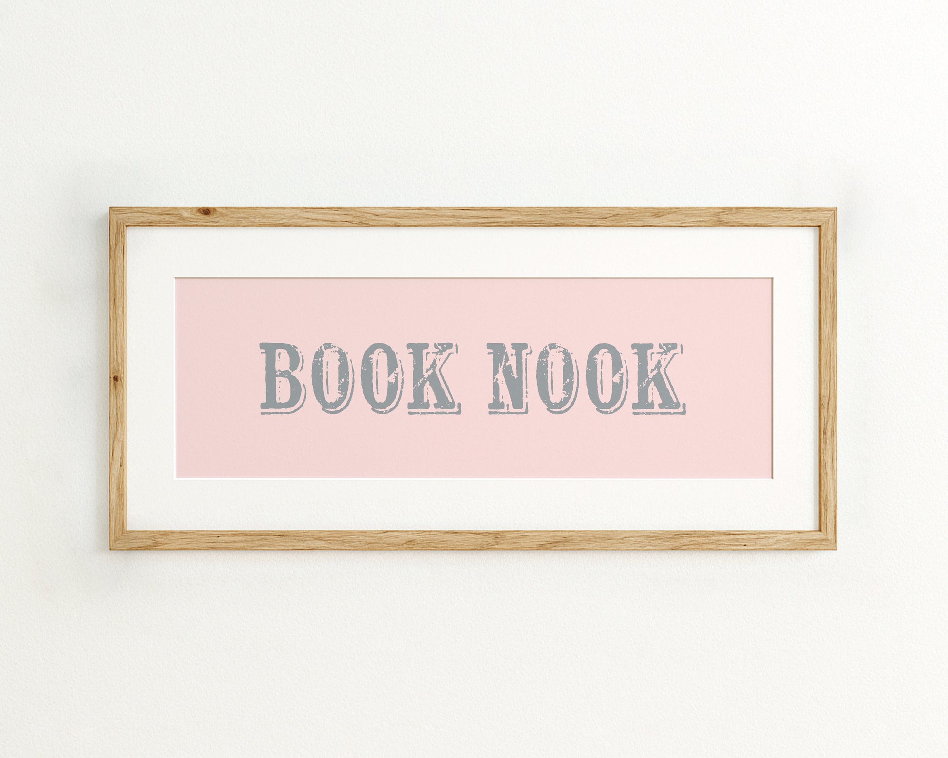 Framed print with 'BOOK NOOK' text on a pink background
