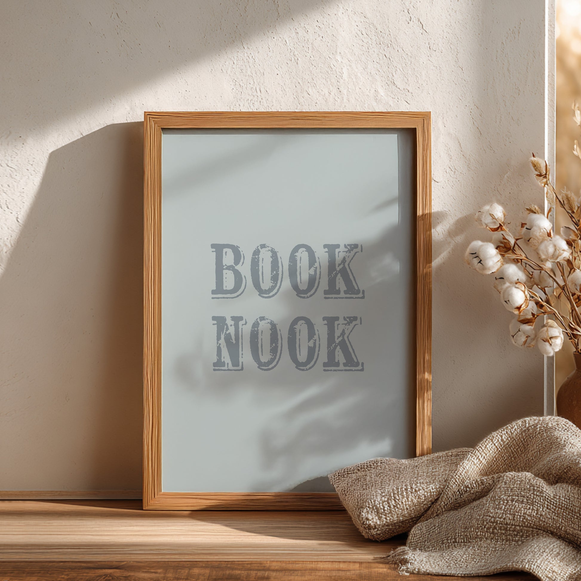 Wooden-framed sign with 'BOOK NOOK' text on a blue background