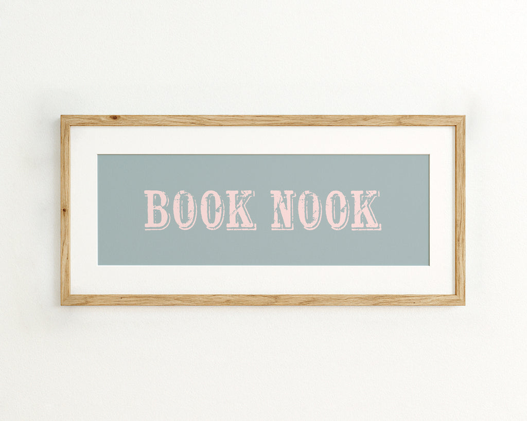 Framed artwork with 'BOOK NOOK' text on a light blue background