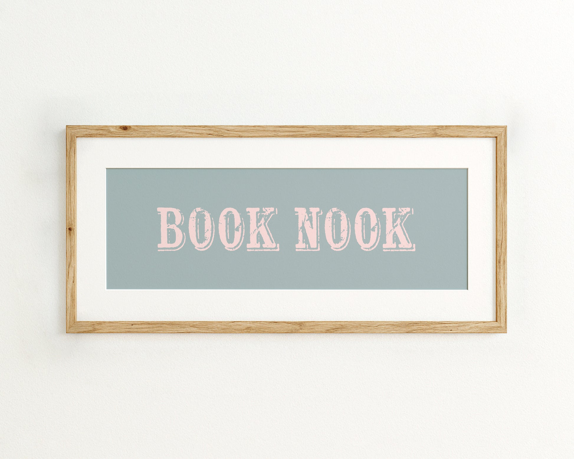 Framed artwork with 'BOOK NOOK' text on a light blue background