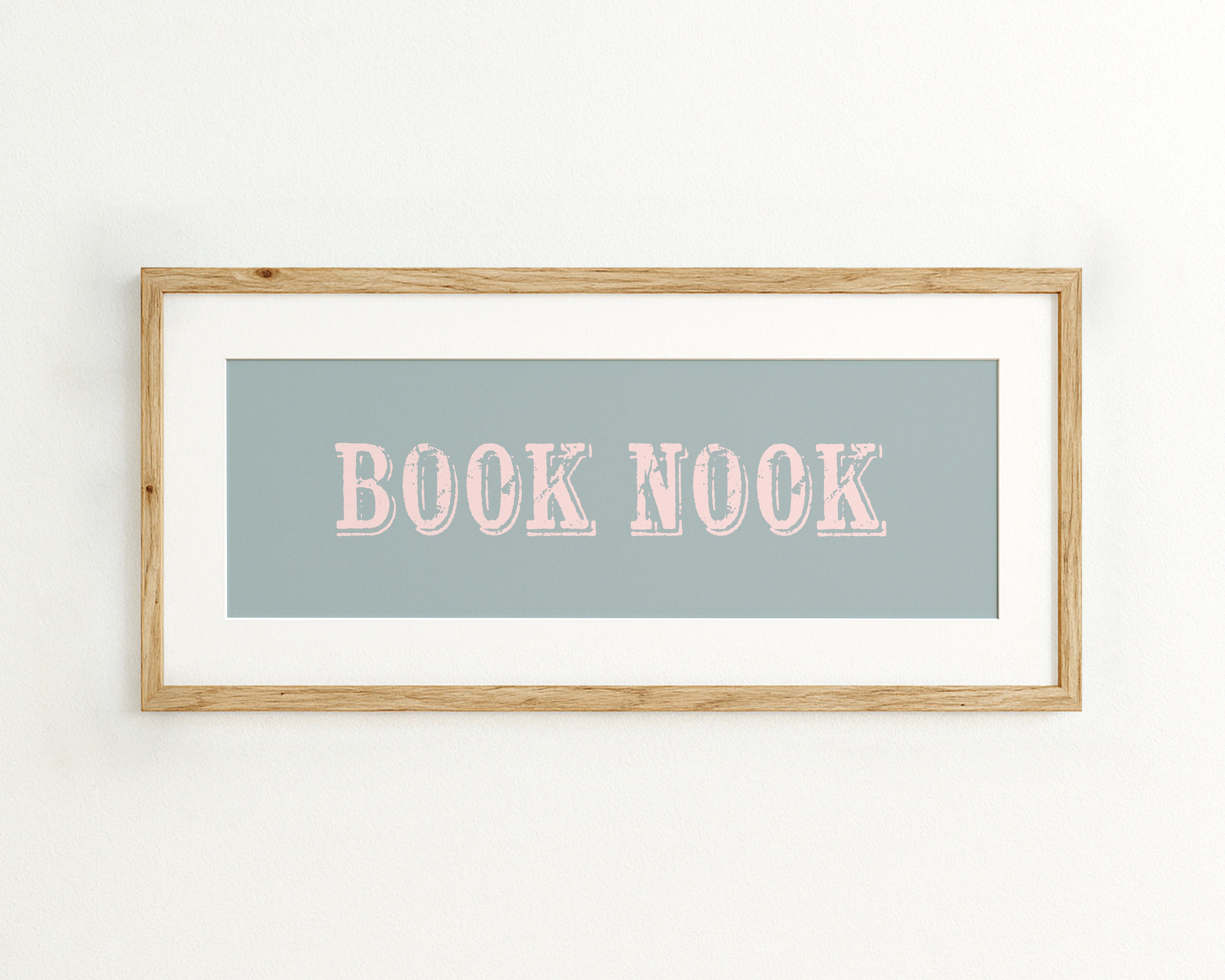 Framed artwork with 'BOOK NOOK' text on a light blue background