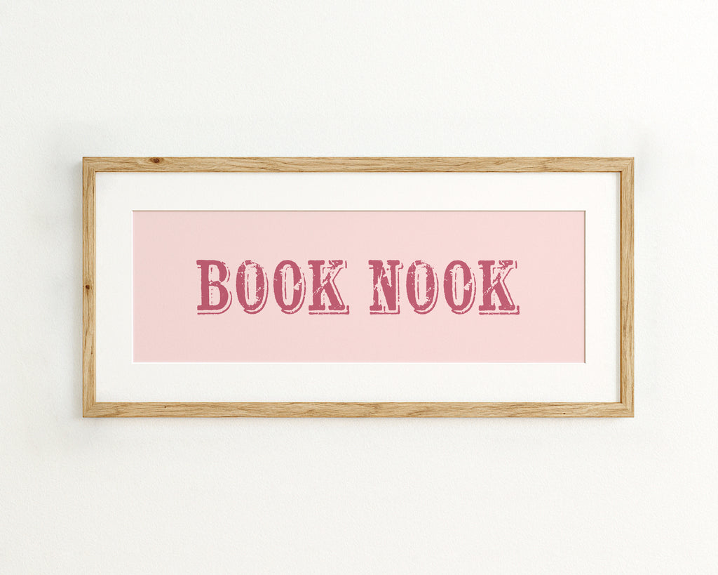 Framed print with 'BOOK NOOK' text on a pink background