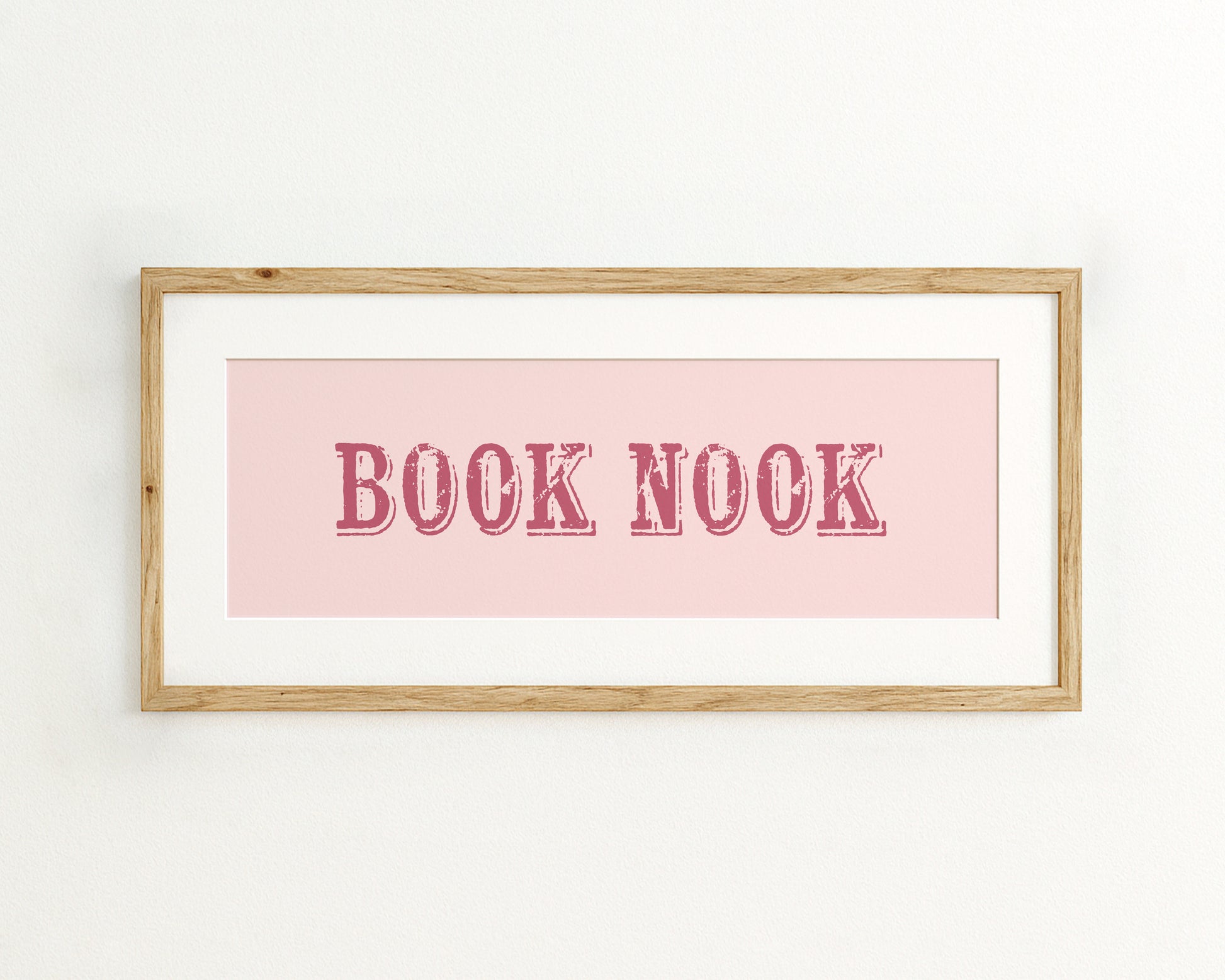 Framed print with 'BOOK NOOK' text on a pink background