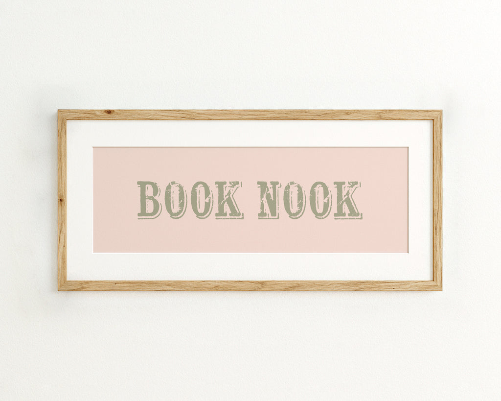 Framed print with 'BOOK NOOK' text on a light pink background