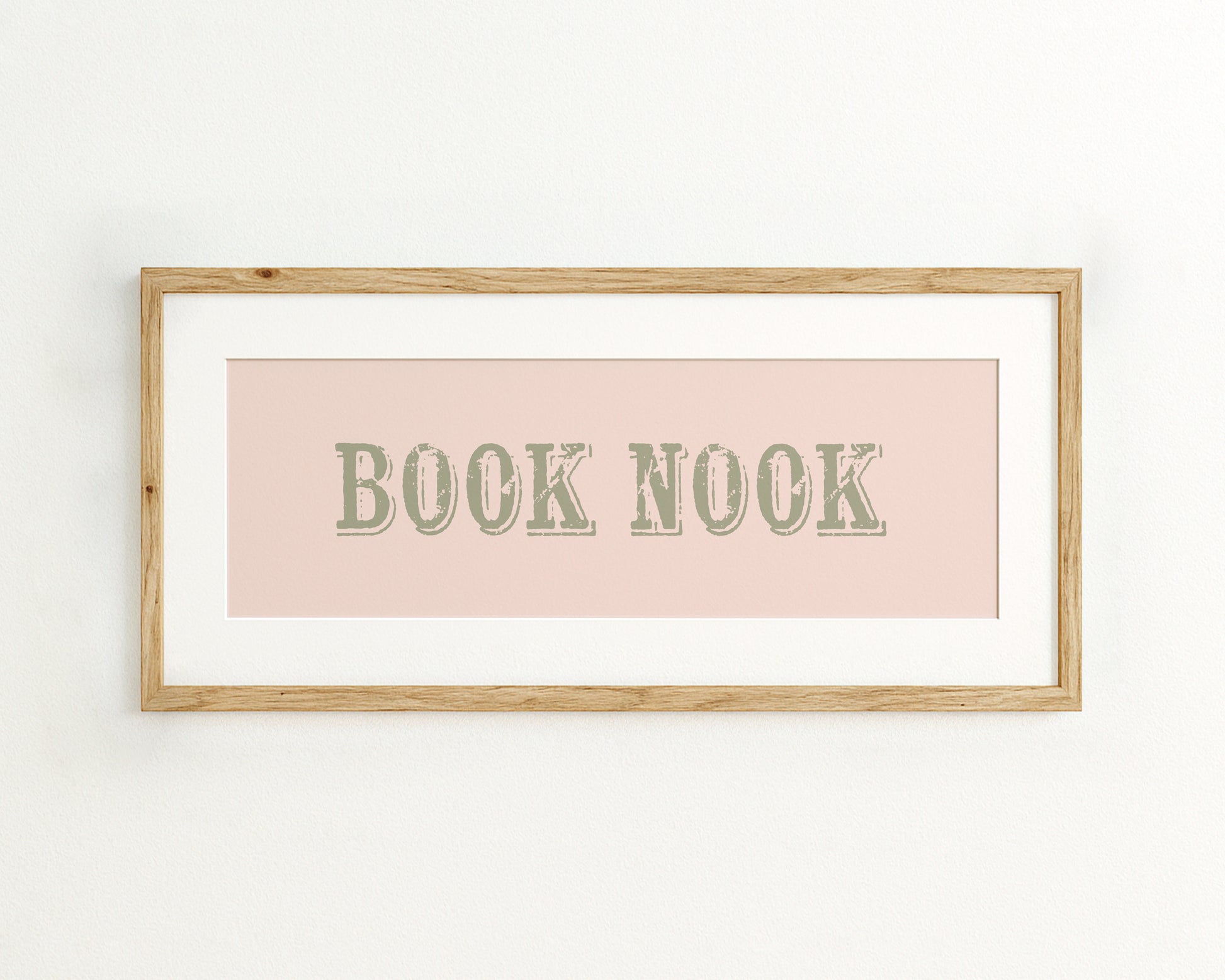 Framed print with 'BOOK NOOK' text on a light pink background