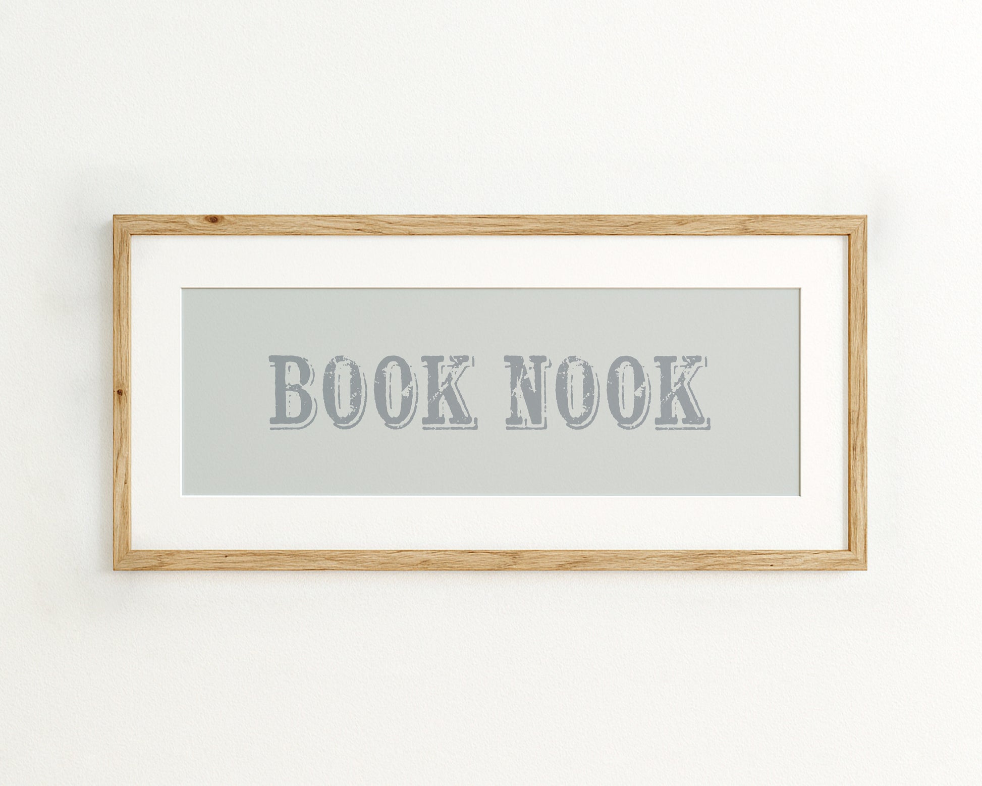 Framed wall art with 'BOOK NOOK' text on a light blue background