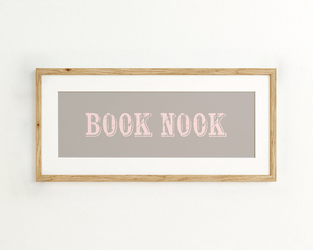 Framed wall art with 'BOOK NOOK' text on a grey background