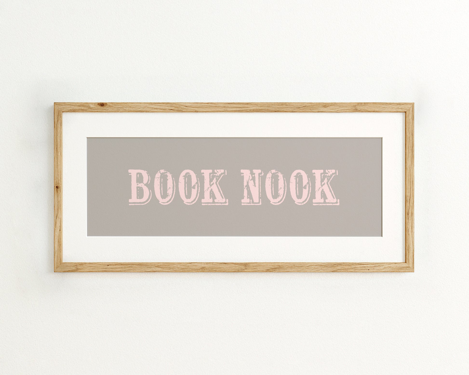 Framed wall art with 'BOOK NOOK' text on a grey background