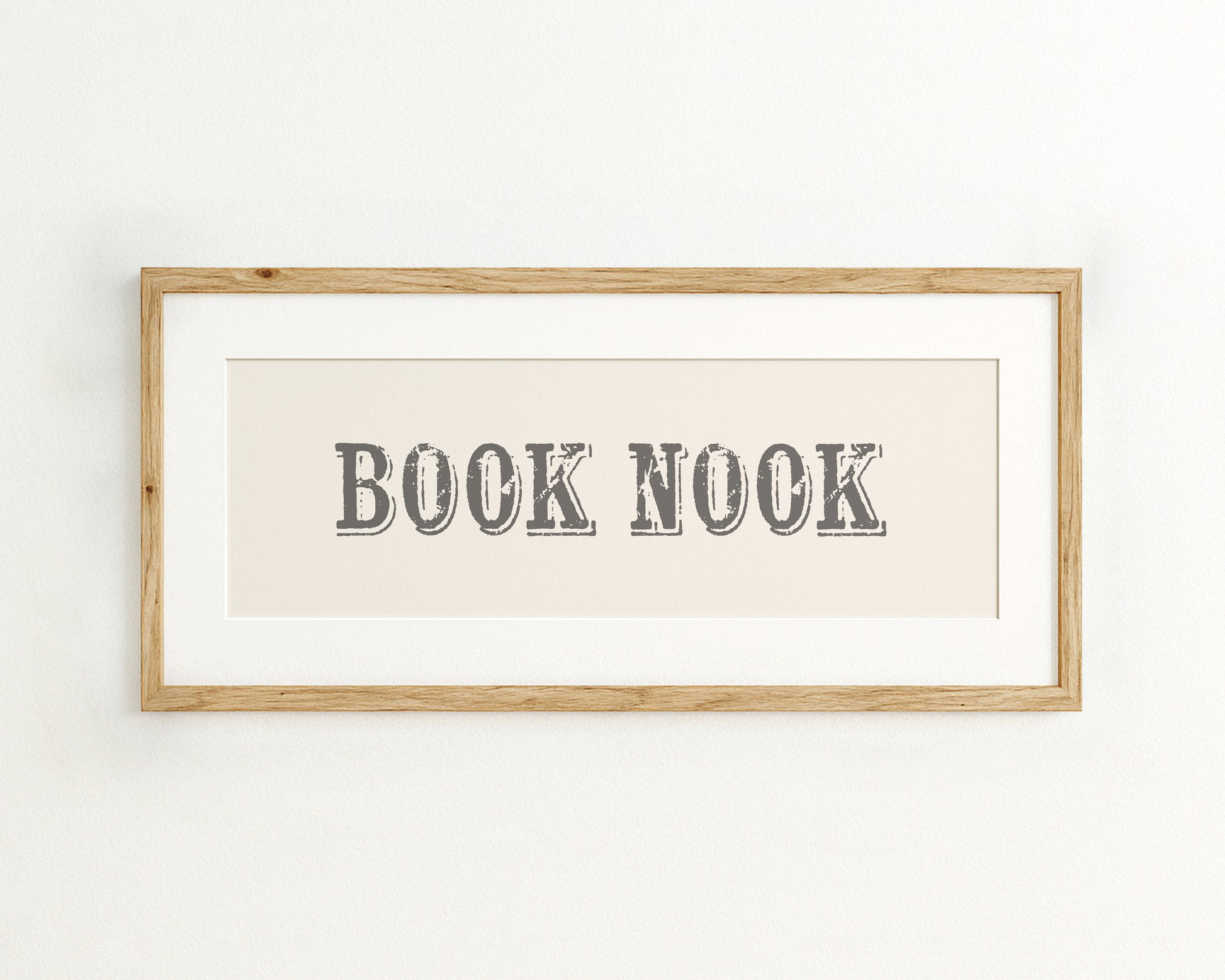 Framed artwork with 'BOOK NOOK' text on a cream background