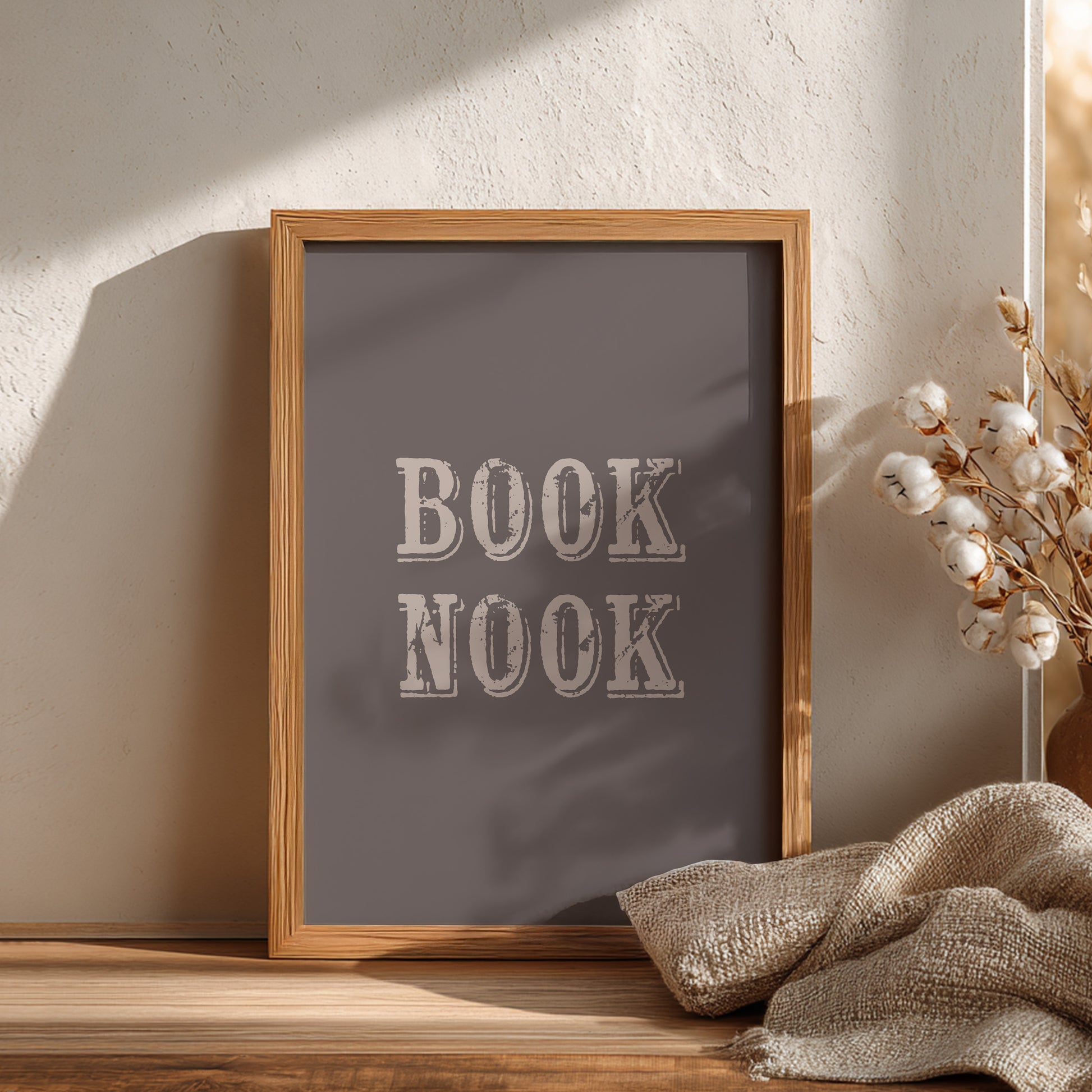 Wooden-framed sign with 'BOOK NOOK' text on a neutral background
