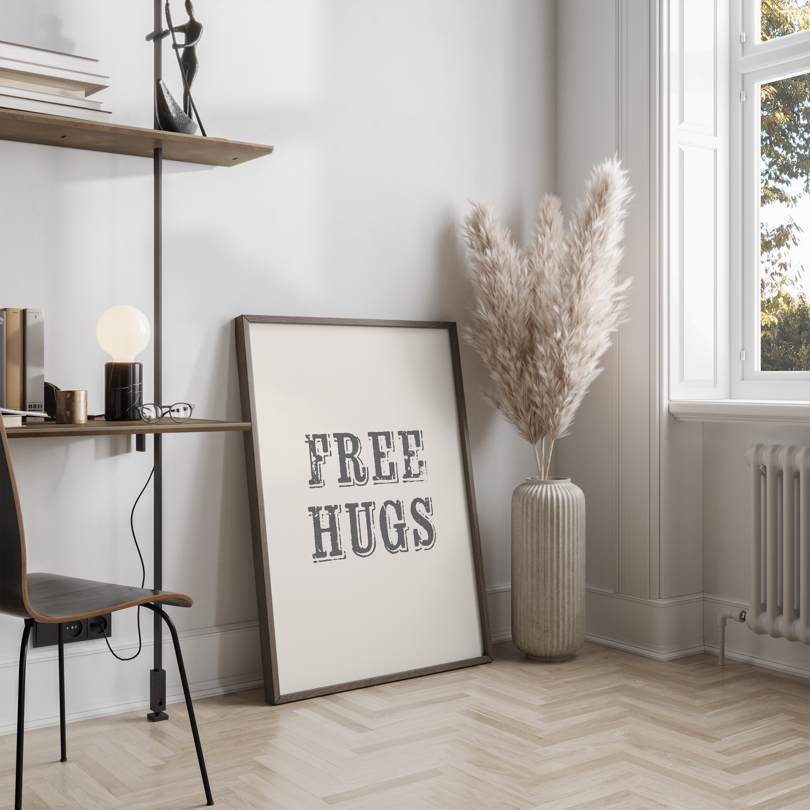 Room interior with a 'FREE HUGS' poster, vase with dried plants, and desk.