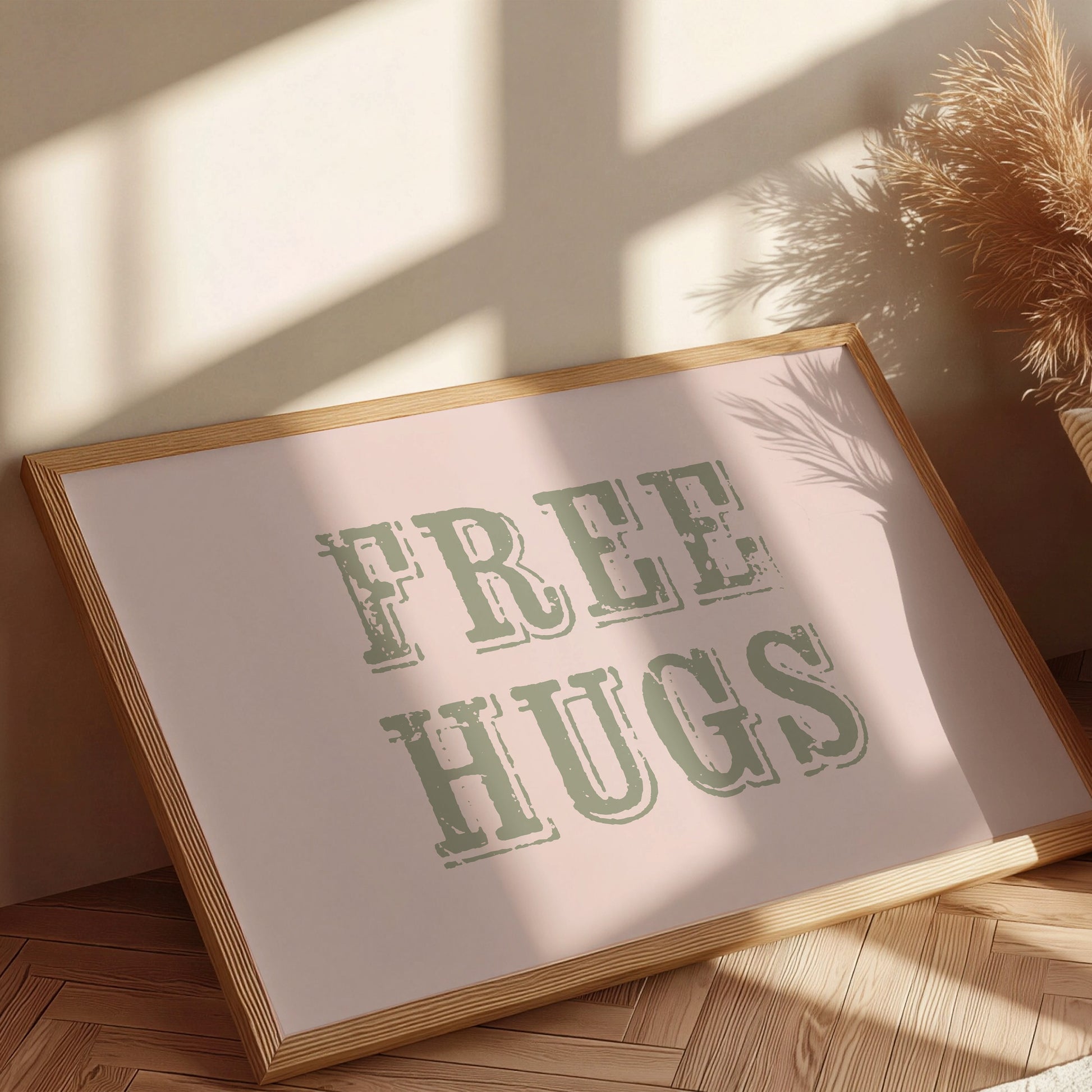 Framed artwork with 'FREE HUGS' text on a light background