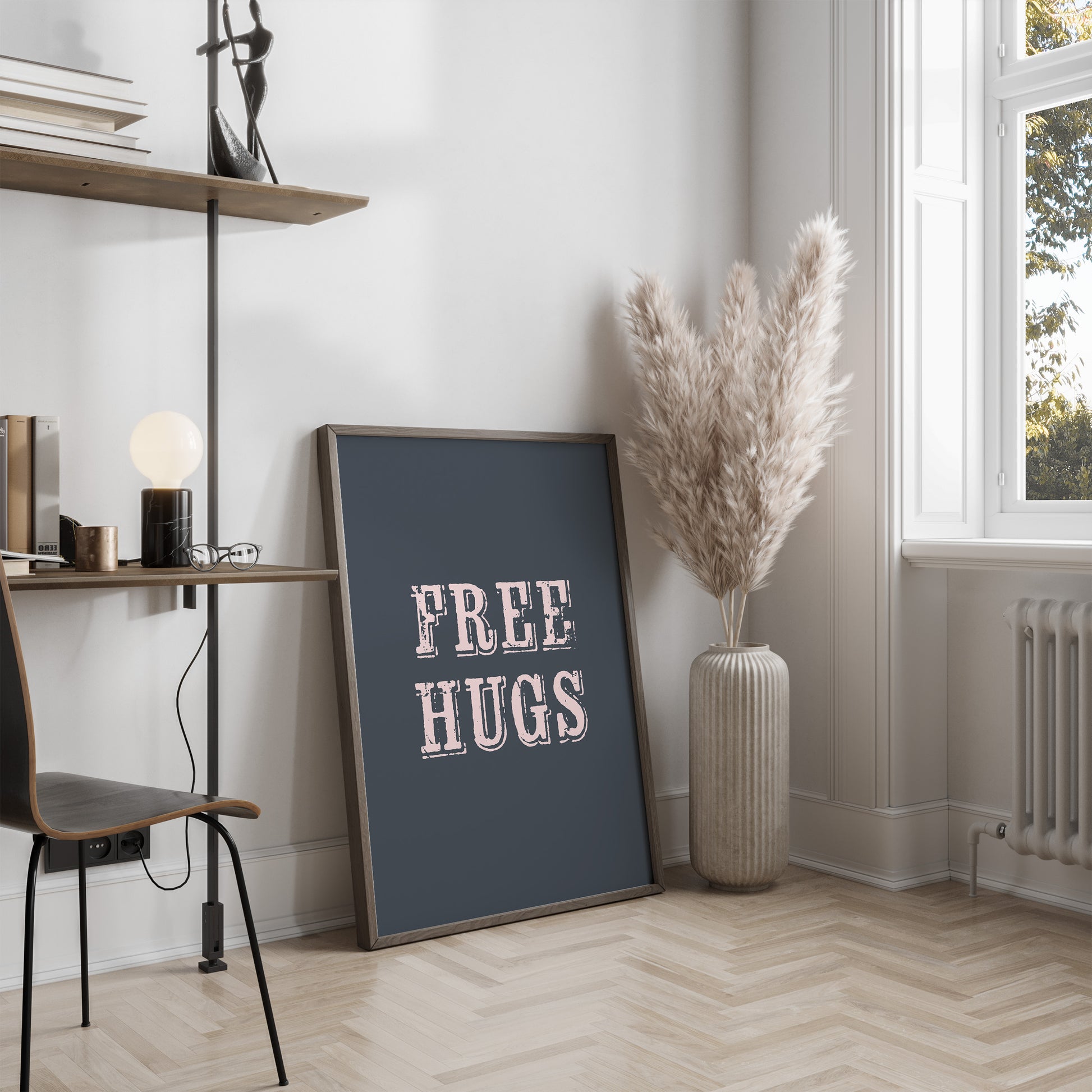 Room interior with a 'FREE HUGS' poster on a wall, a vase with dried plants, and a chair.