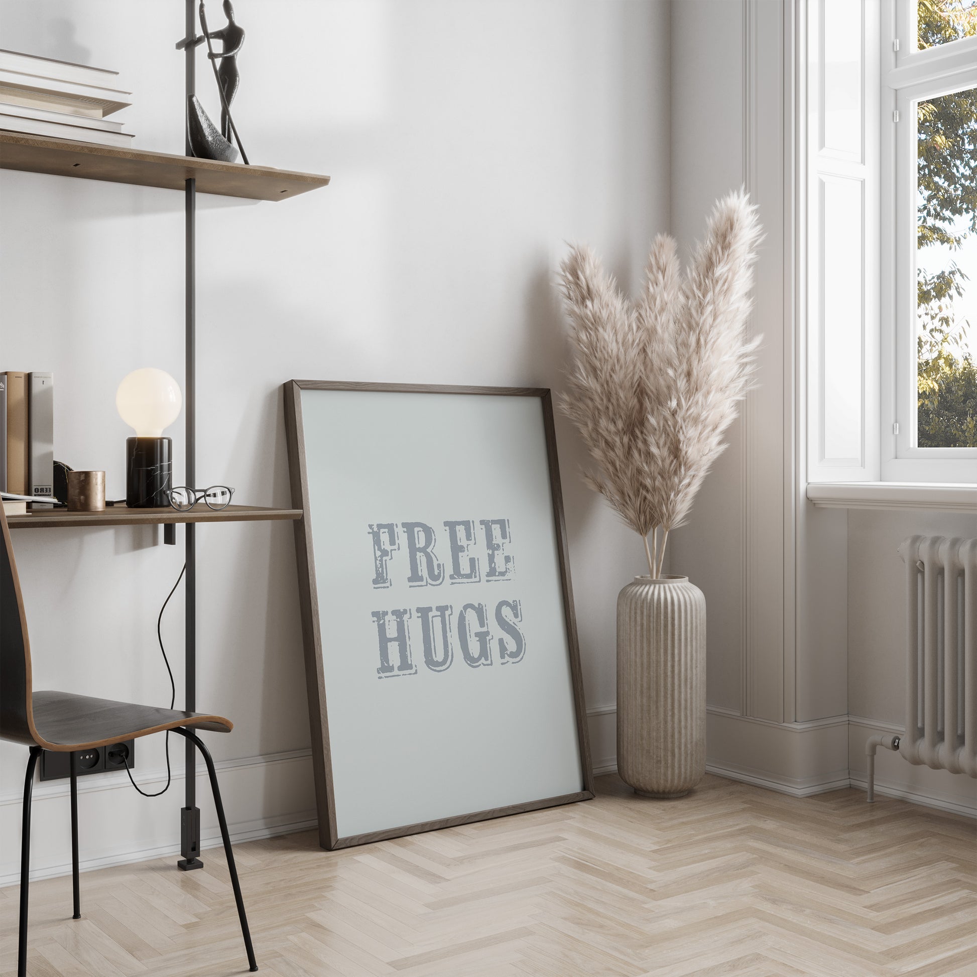 Room interior with a 'FREE HUGS' poster, vase with dried plants, and desk.