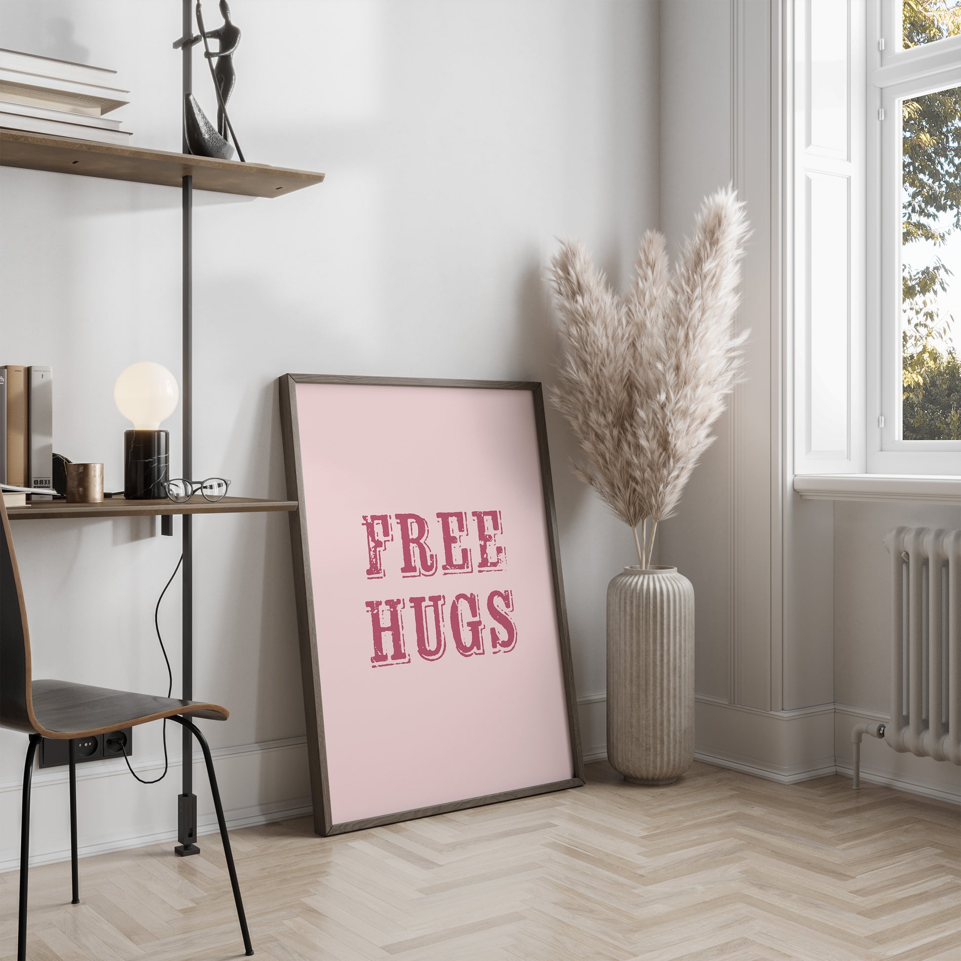 Room interior with a 'FREE HUGS' poster on a wall, a vase with dried plants, and a shelf.