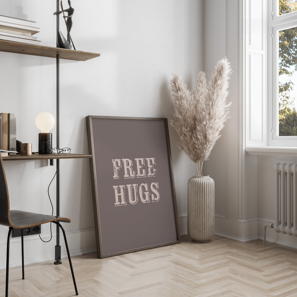 Room interior with a 'FREE HUGS' poster on a wall, a vase with dried plants, and a chair.