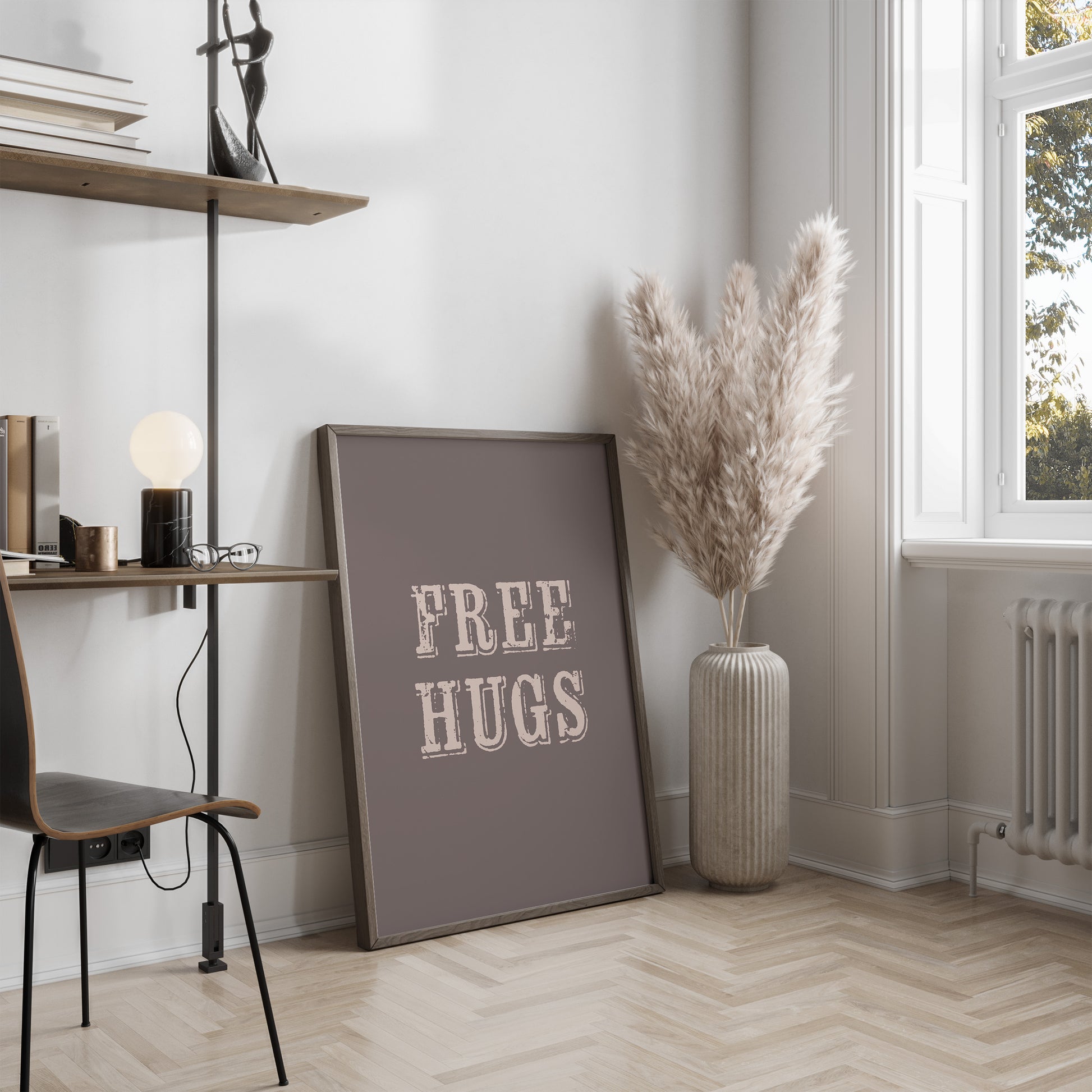 Room interior with a 'FREE HUGS' poster on a wall, a vase with dried plants, and a chair.