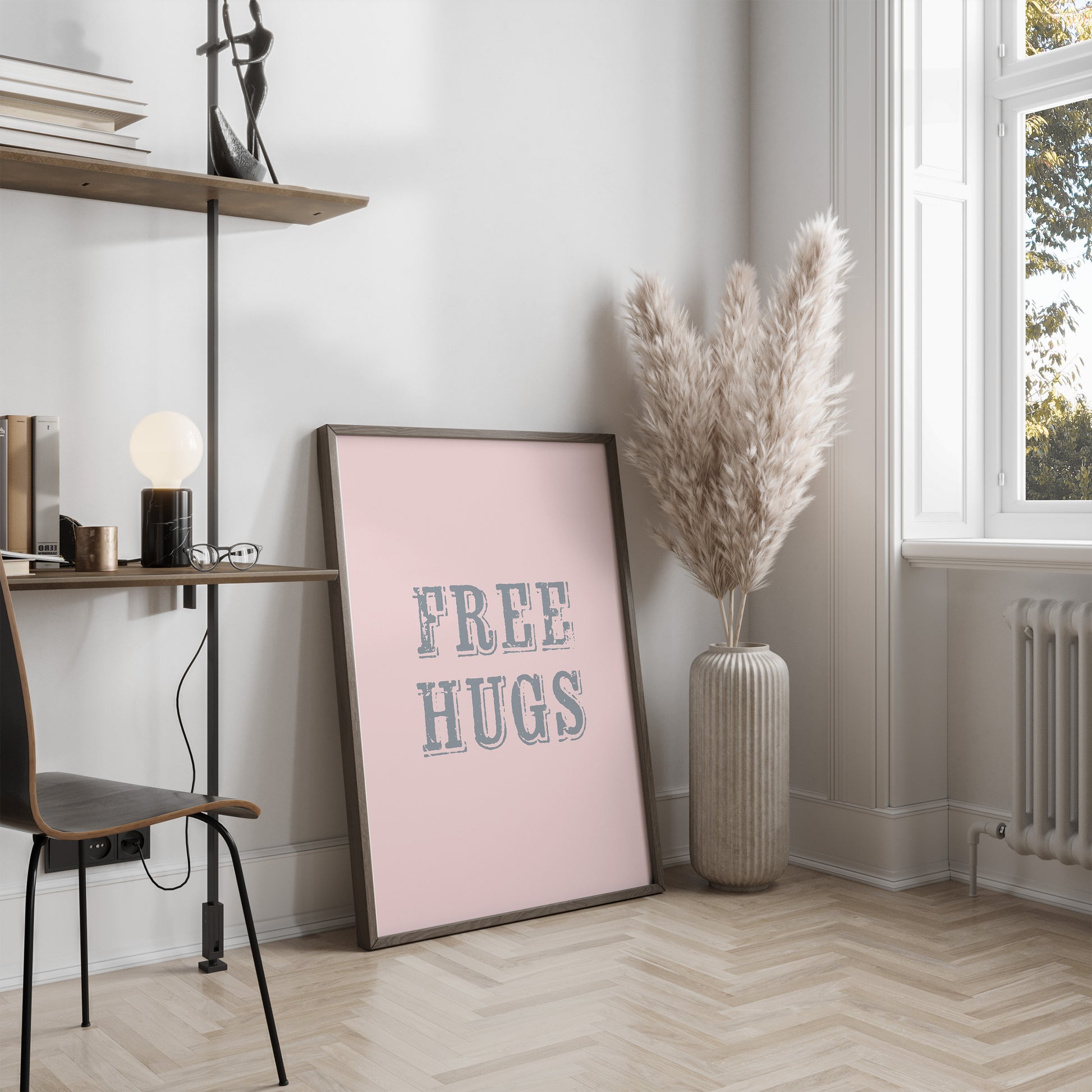 Room interior with a 'Free Hugs' poster on a wall, a vase with dried plants, and a shelf.