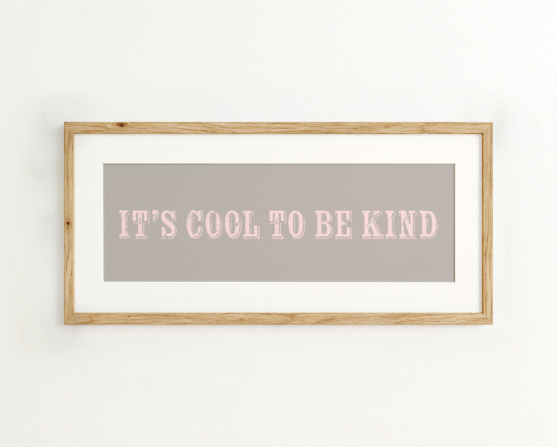 Framed quote 'IT'S COOL TO BE KIND' on a grey background
