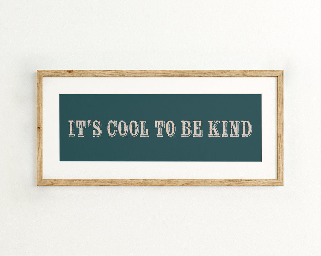 Framed artwork with 'It's Cool to be Kind' text on a teal background