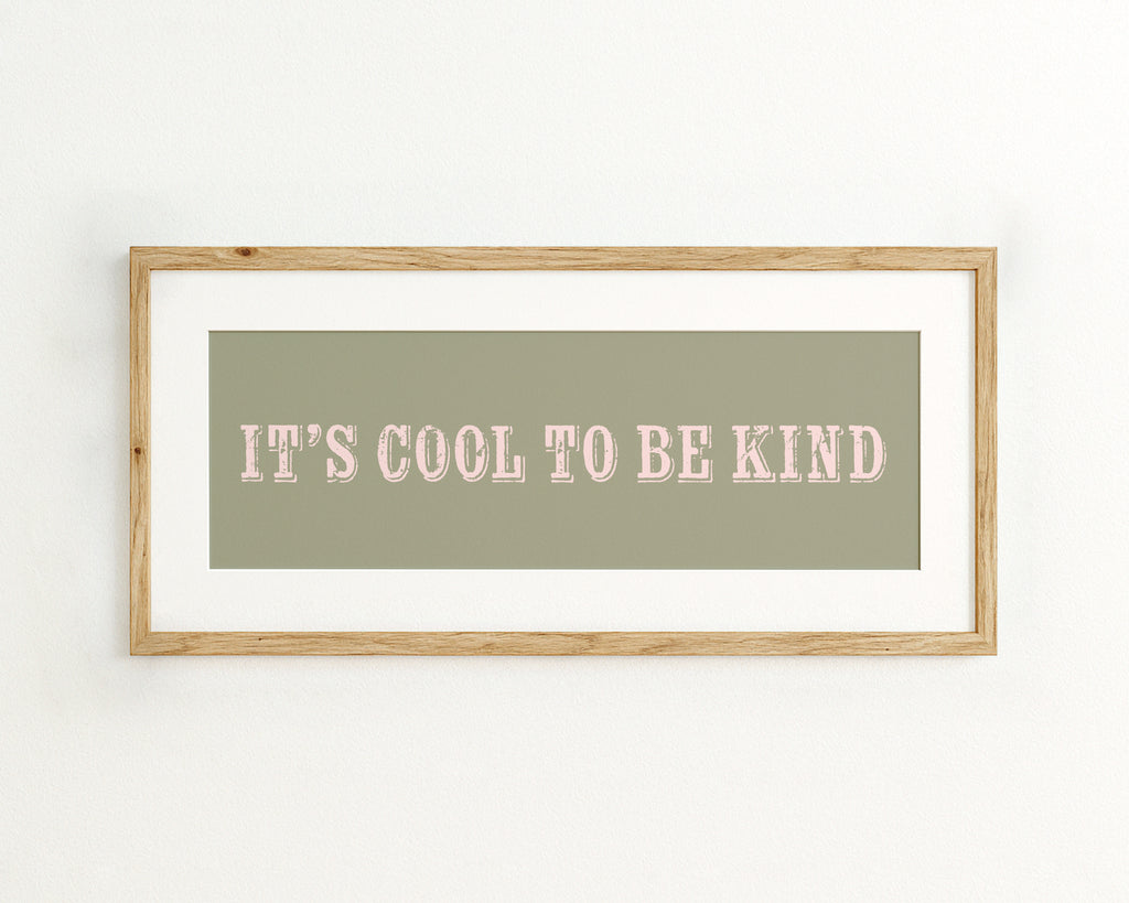 Framed print with 'It's cool to be kind' text on a green background