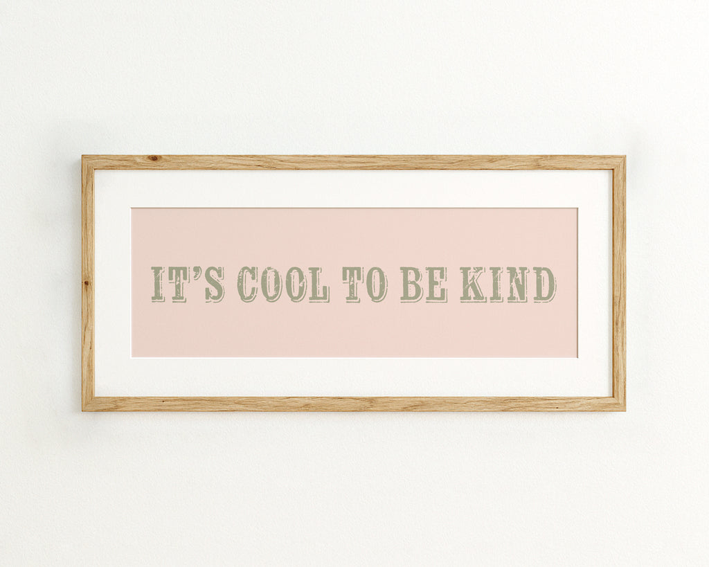 Framed quote 'It's cool to be kind' on a pink background