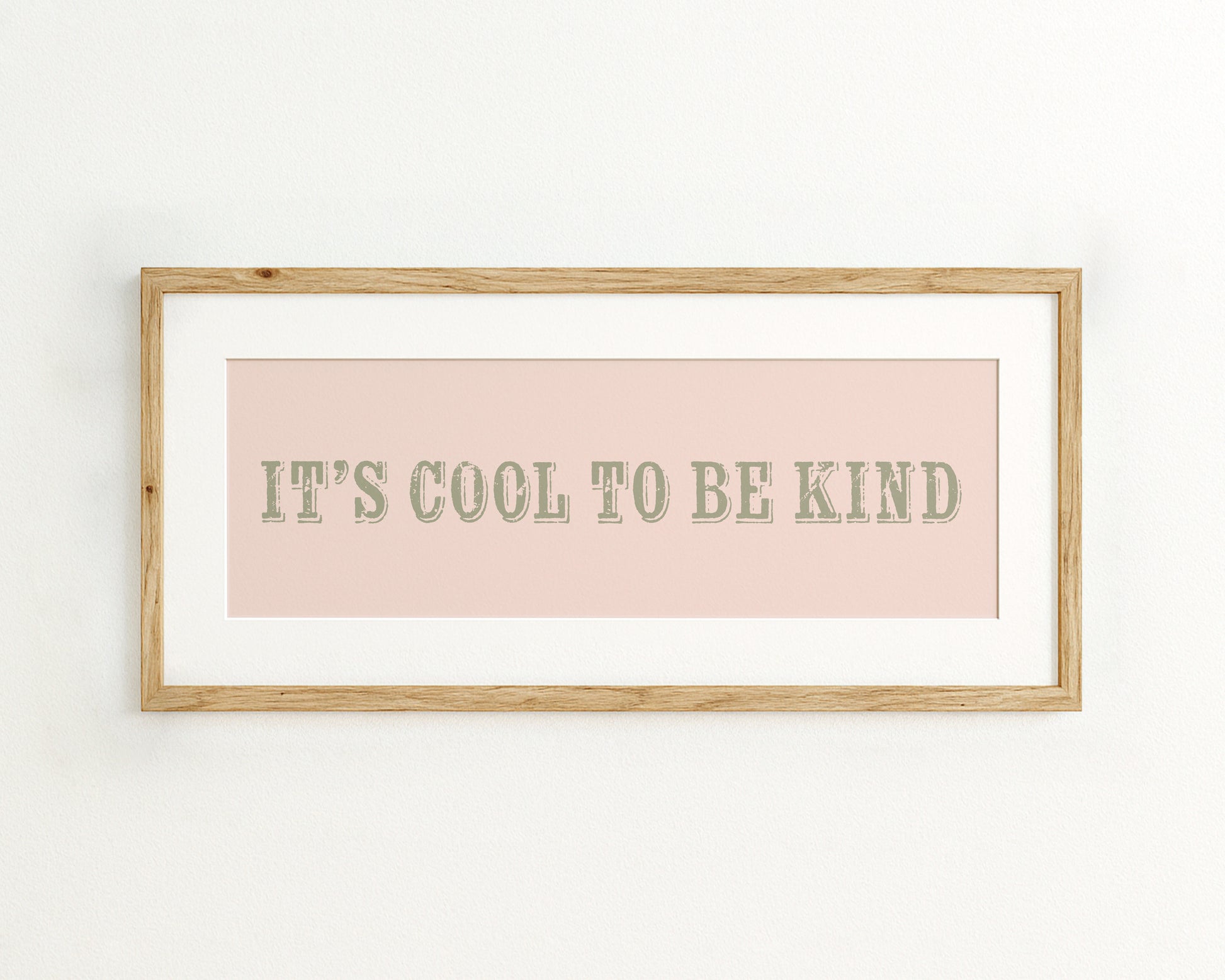 Framed quote 'It's cool to be kind' on a pink background