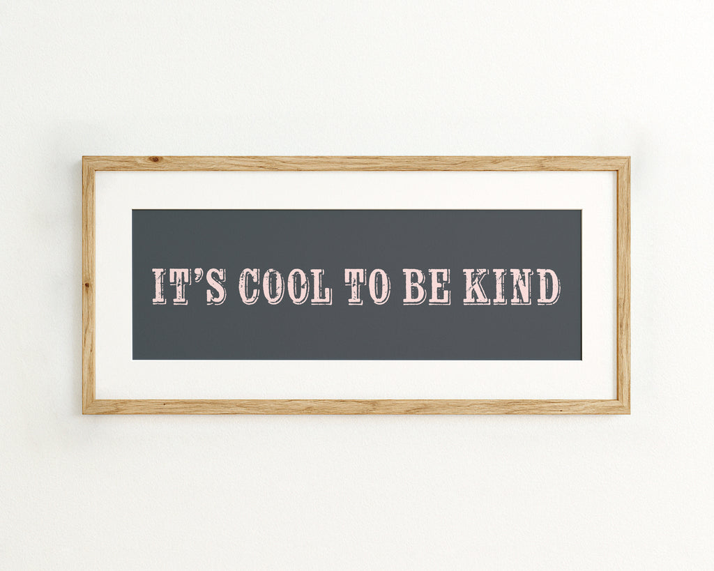 Framed quote 'IT'S COOL TO BE KIND' on a dark blue background