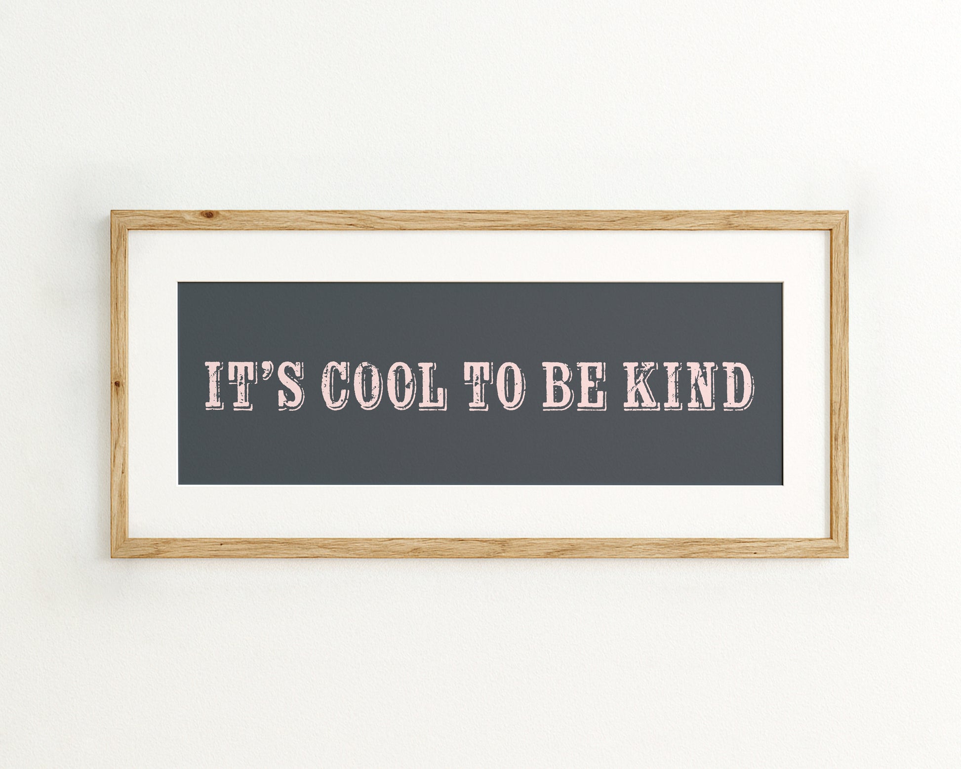 Framed quote 'IT'S COOL TO BE KIND' on a dark blue background