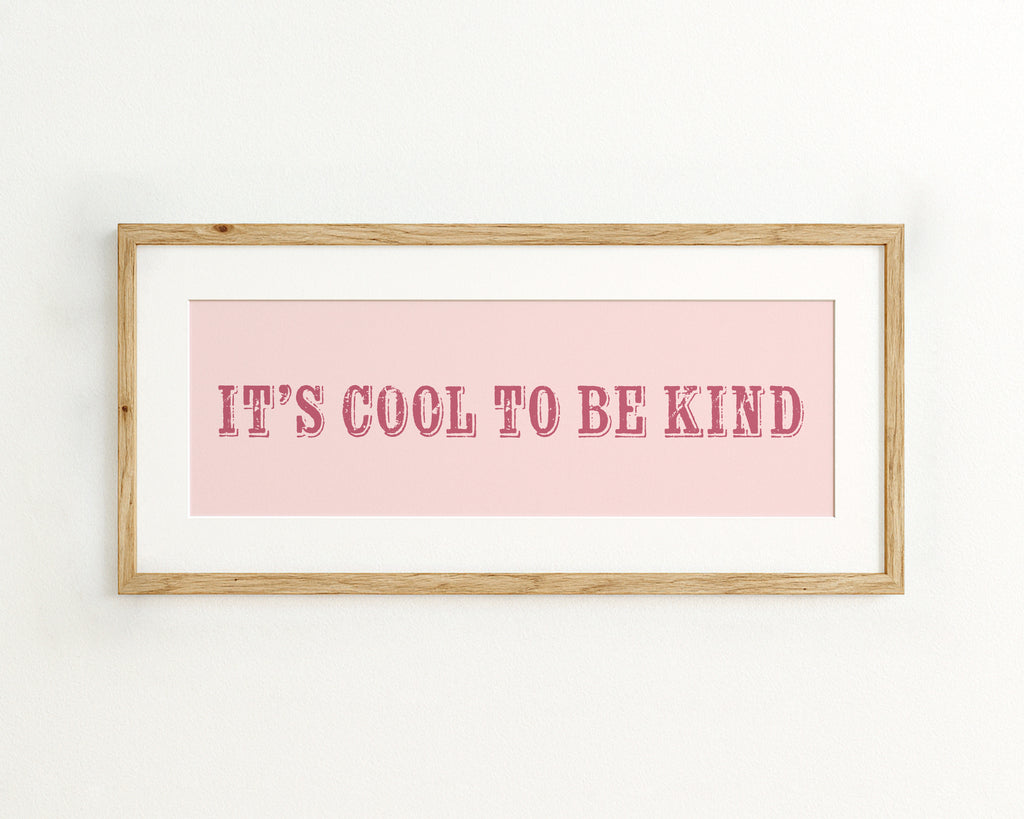 Framed poster with 'It's cool to be kind' text on a pink background