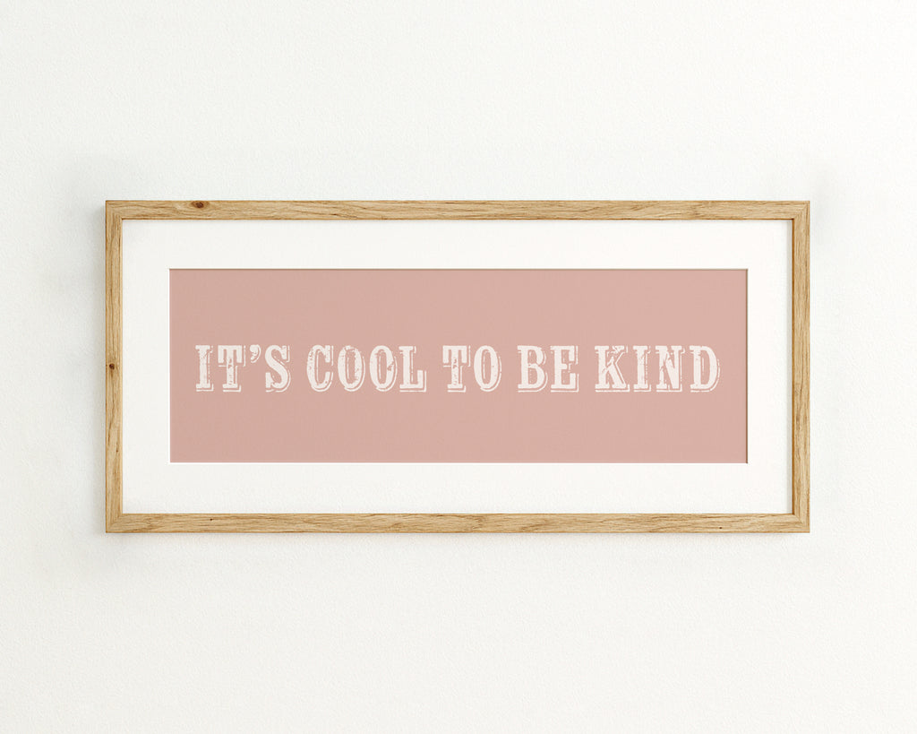 Framed quote 'It's cool to be kind' on a pink background