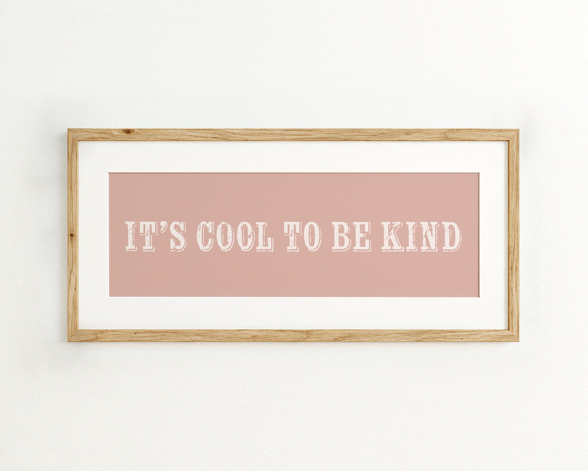 Framed quote 'It's cool to be kind' on a pink background