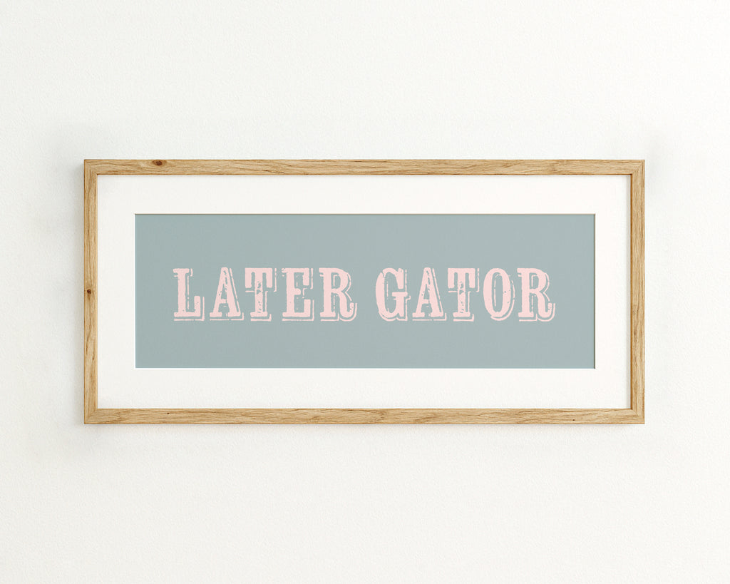 Framed print with 'LATER GATOR' text on a light blue background